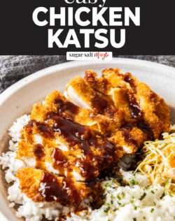 Sliced chicken katsu on a bed of rice and cabbage.