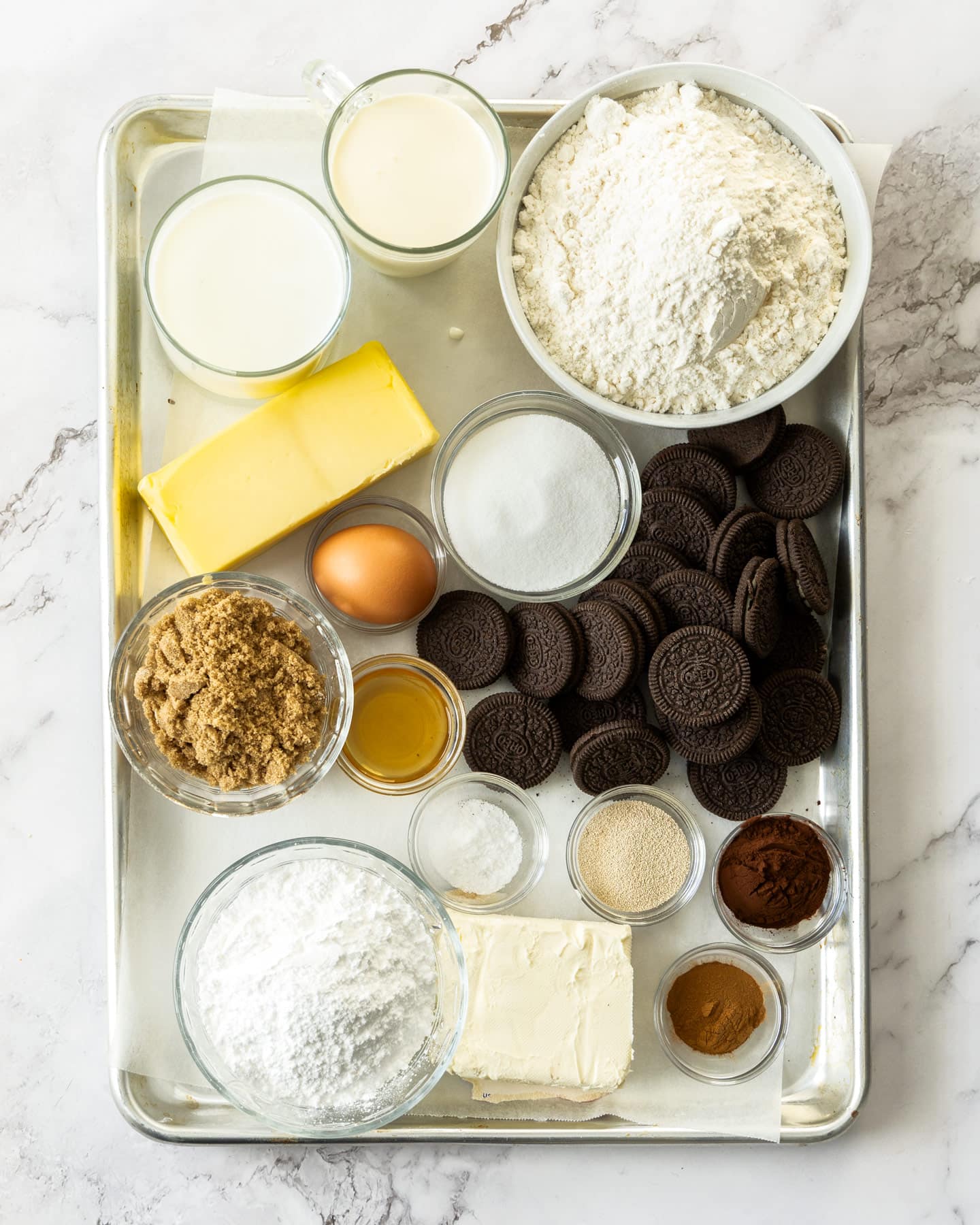 Ingredients for Oreo cinnamon rolls on a baking tray.