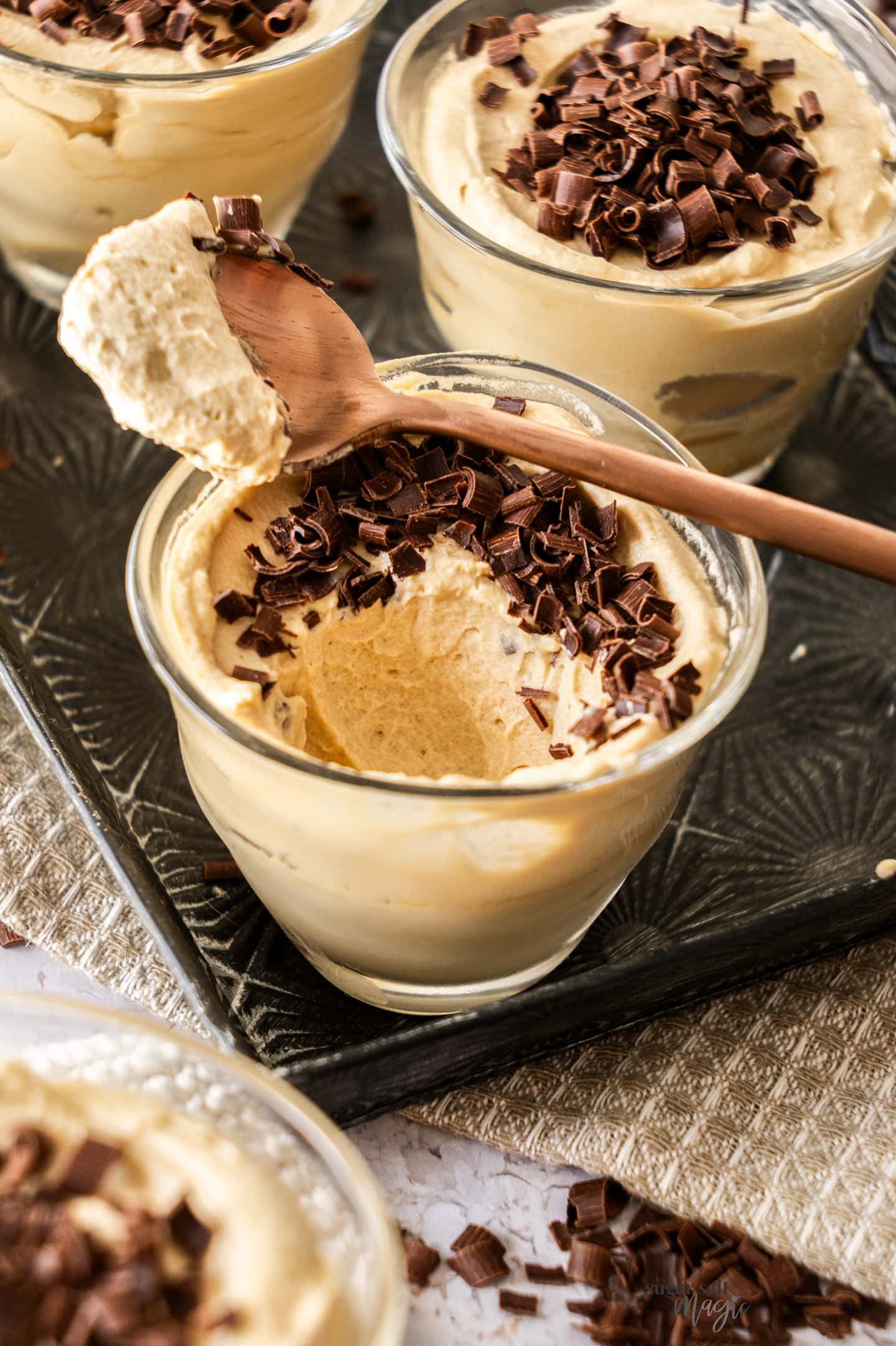 A coffee mousse with a spoonful taken from it.