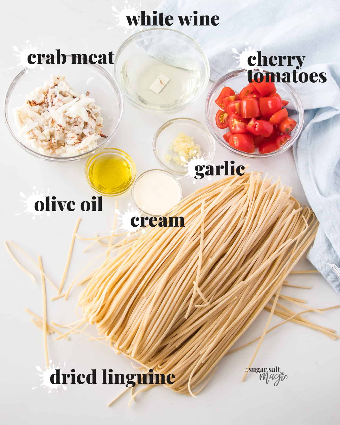 overhead: crab pasta ingredients on a benchtop