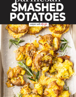 A batch of smashed potatoes on a baking tray.