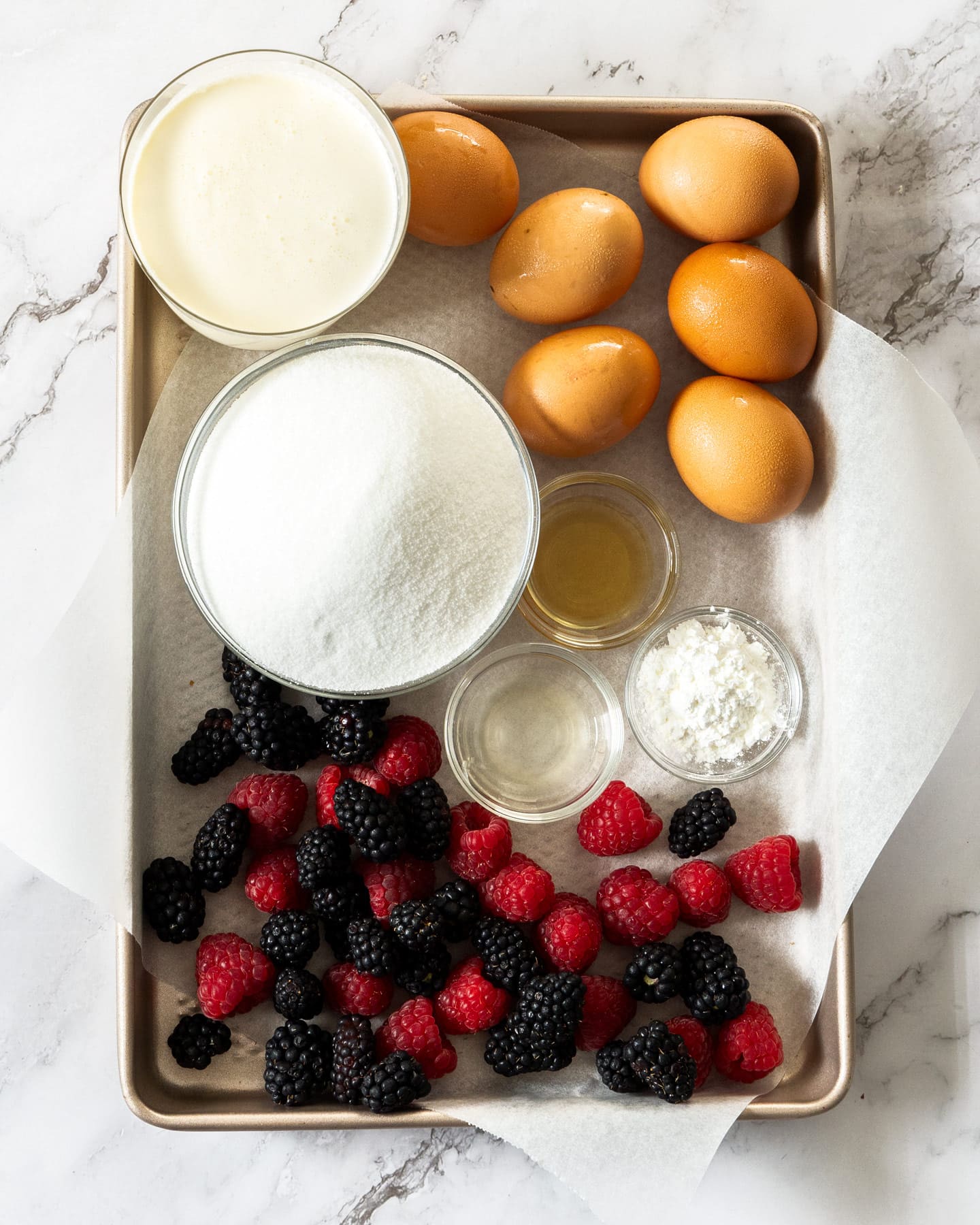 The ingredients for pavlova wreath on a baking tray.