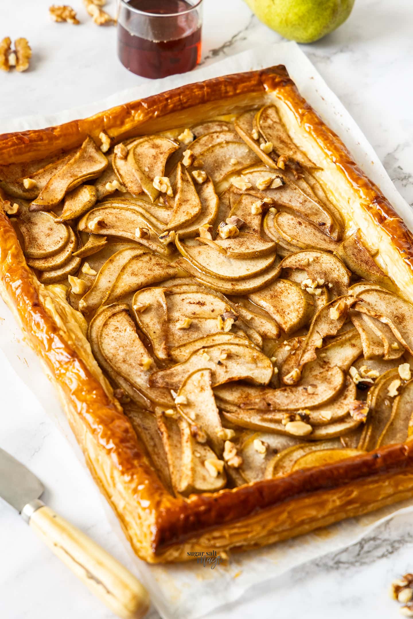 A whole puff pastry pear tart ready to serve.