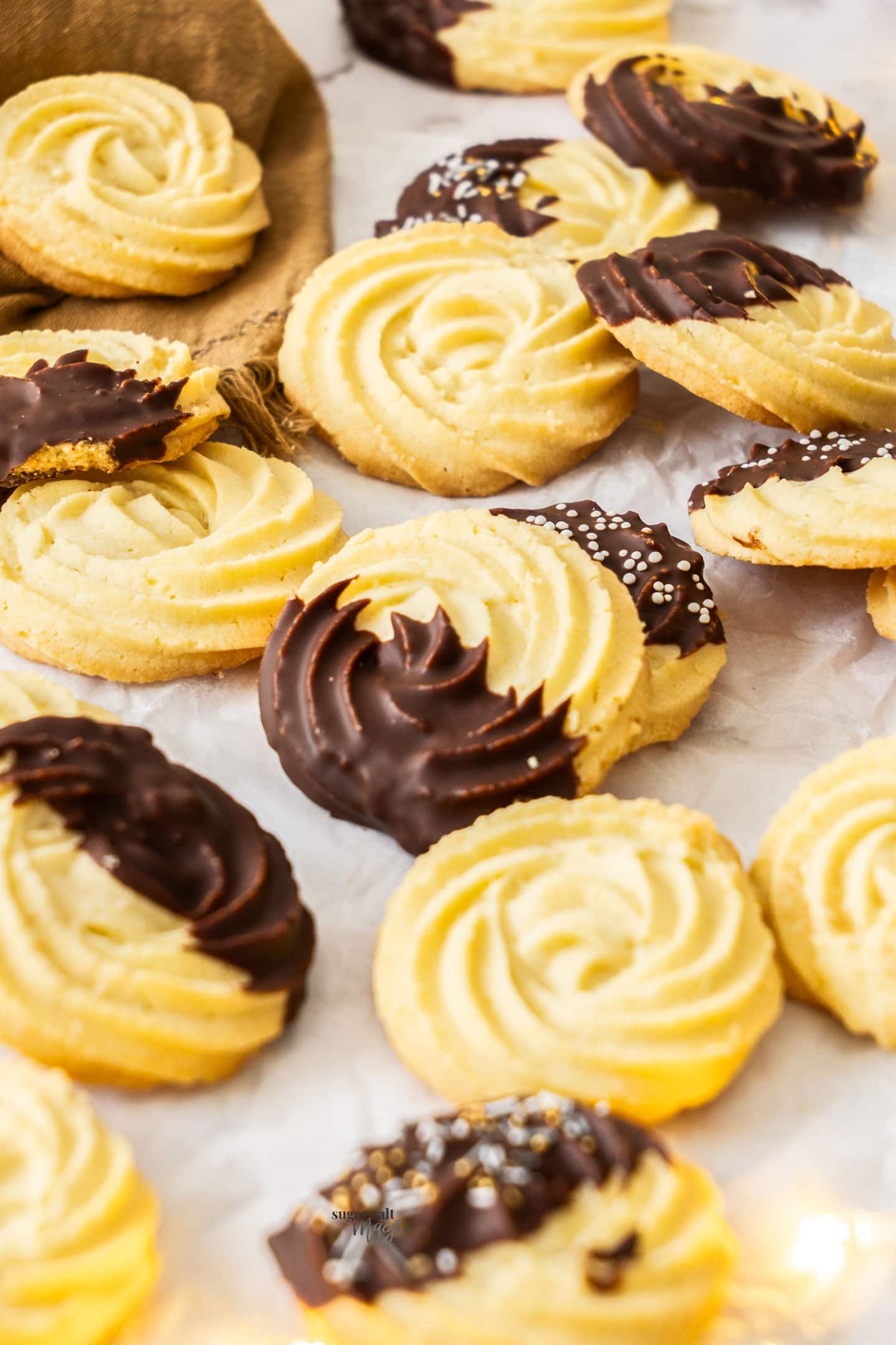 A whole batch of Danish butter cookies, some with a chocolate coating.