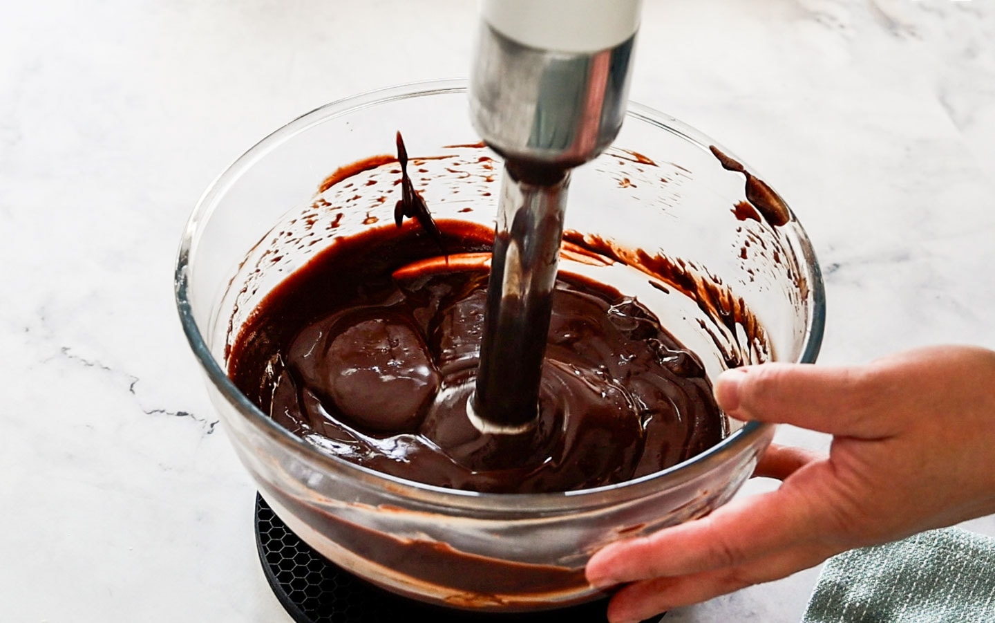 Using an immersion blender to smooth the cremeux.
