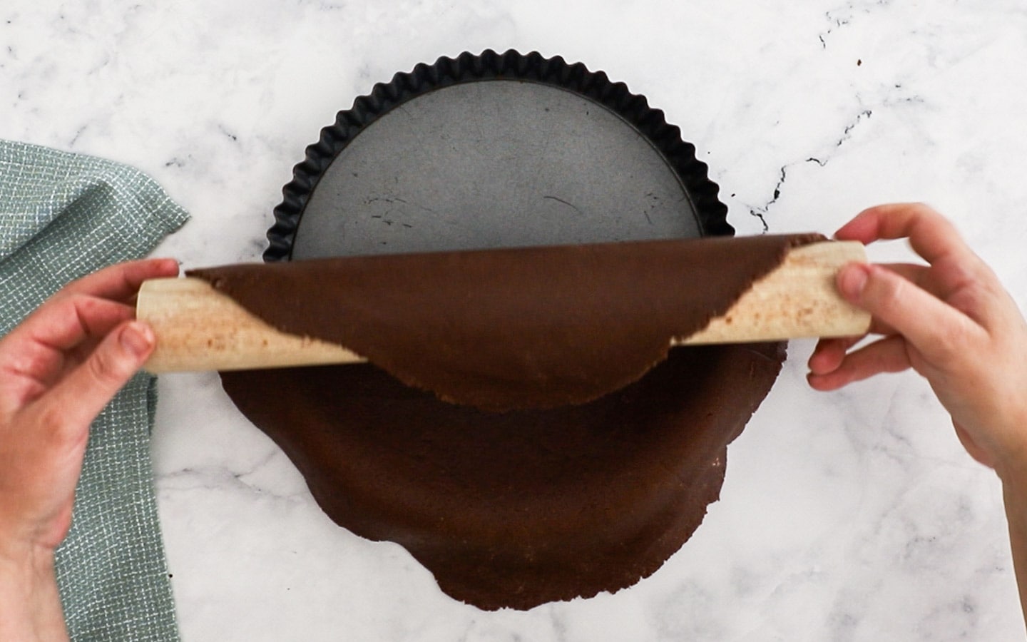 Placing the pastry dough into the tart pan.