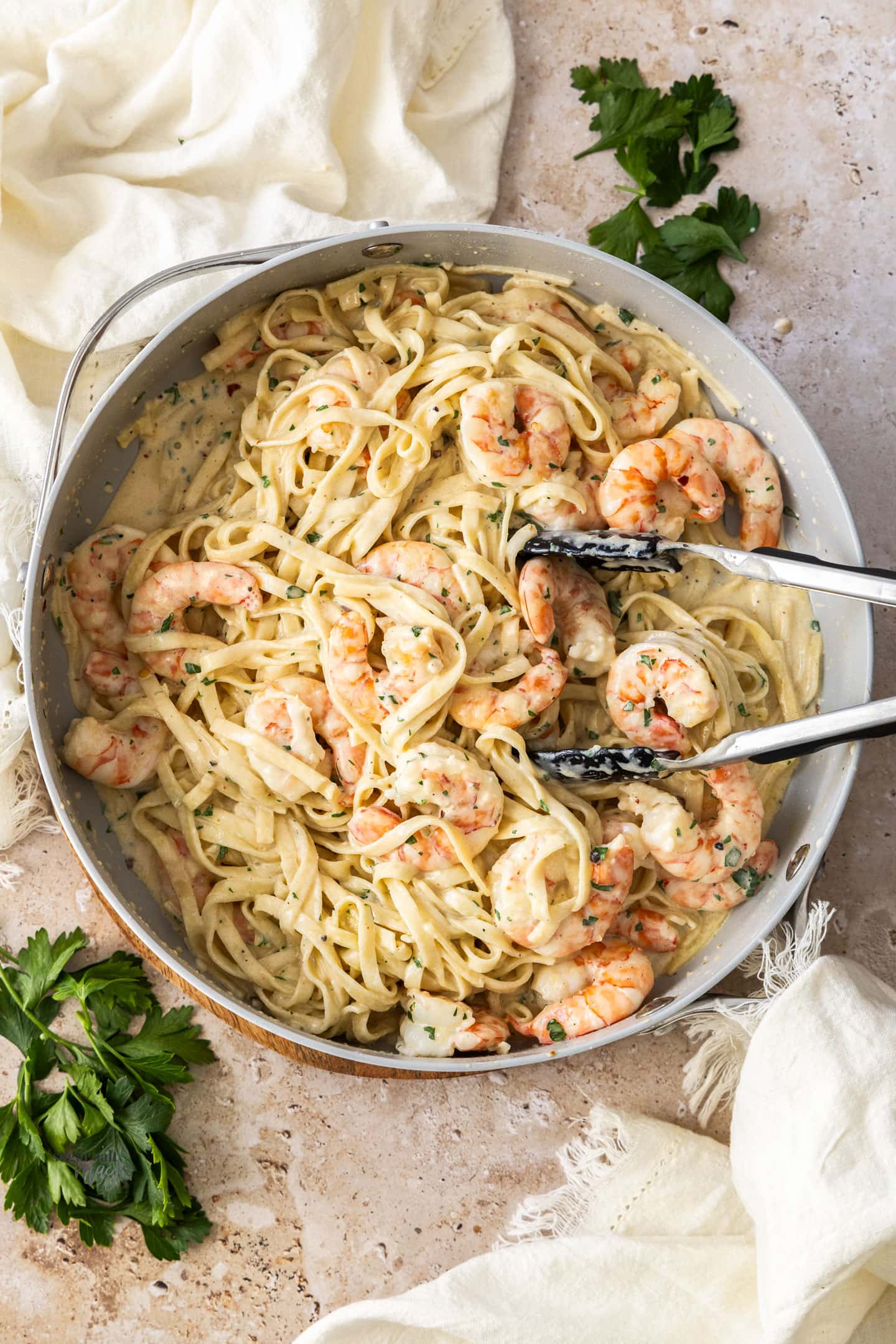 Top down view of creamy prawn pasta in a pan.