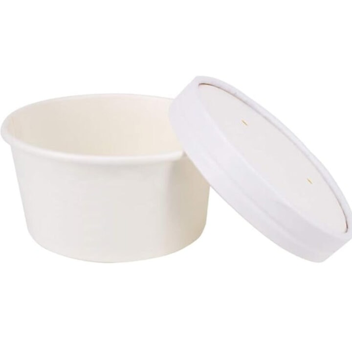 A cardboard ice cream cup with a lid sitting at an angle.