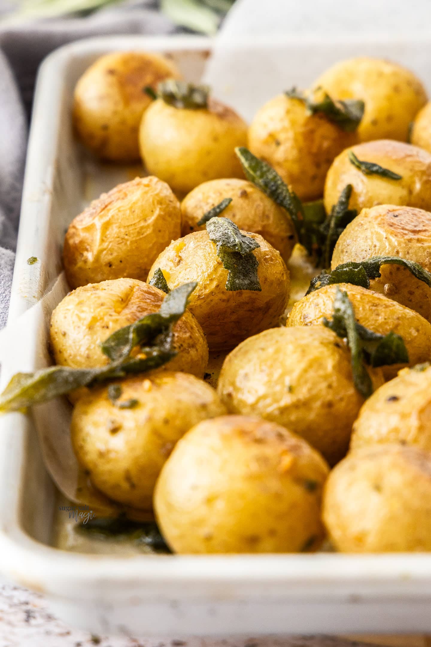 Closeup of roasted baby potatoes with sage.