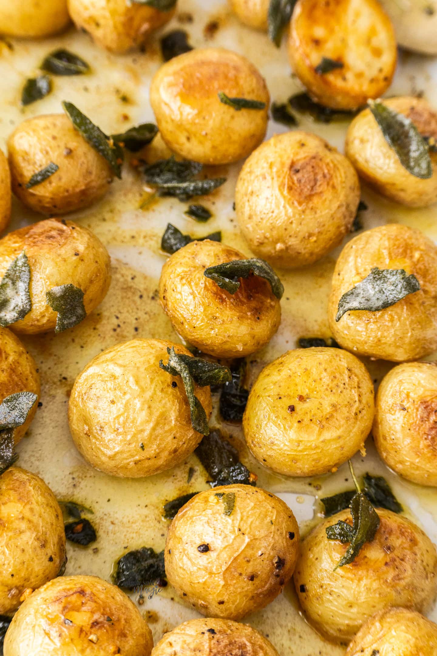 A batch of roasted potatoes dressed with sage butter.