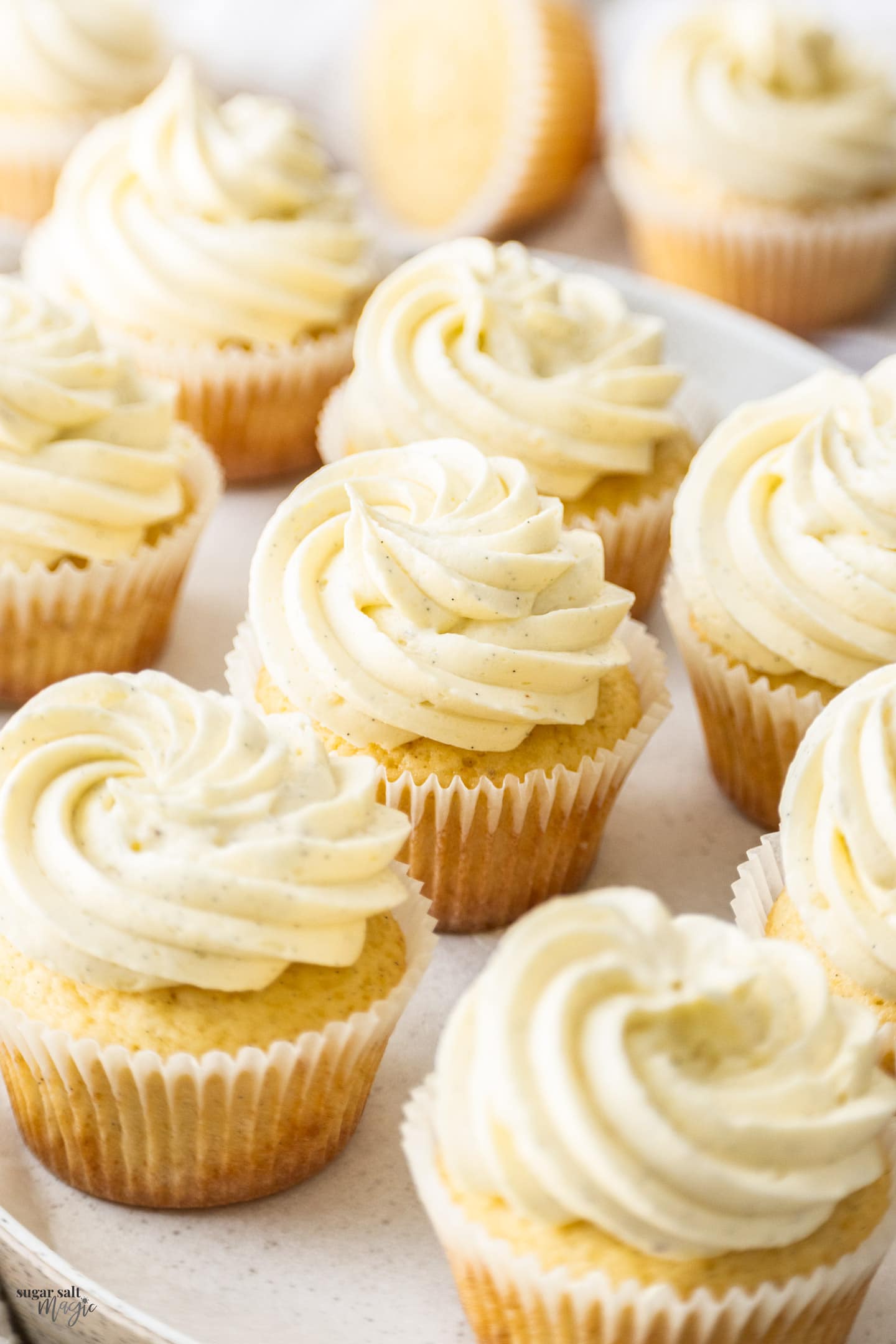 Closeup of a batch of vanilla cupcakes.
