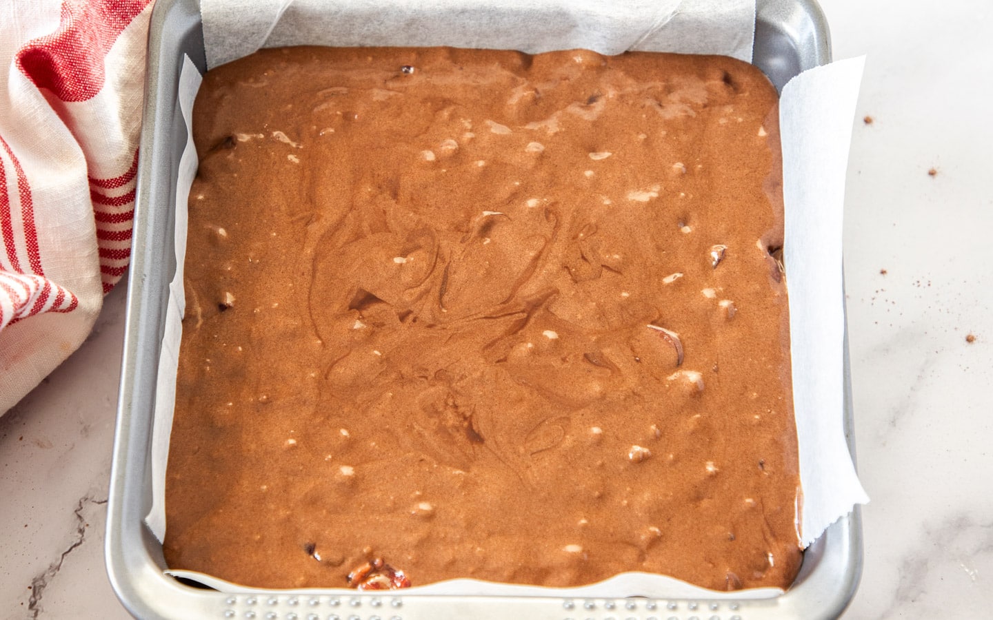 The cherry brownie batter in a baking pan.