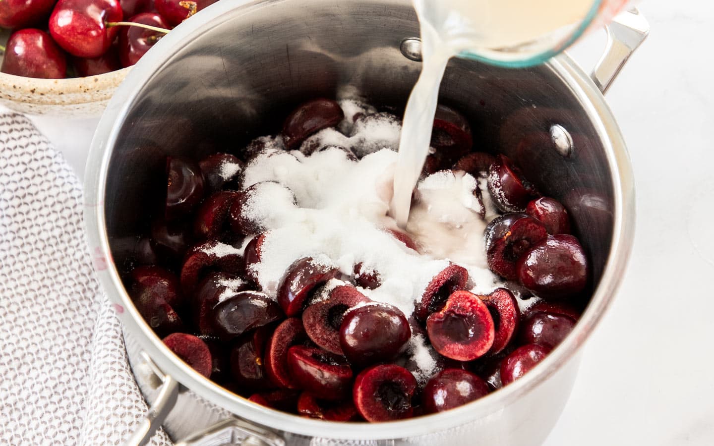 Ingredients for cherry sauce in a pan.