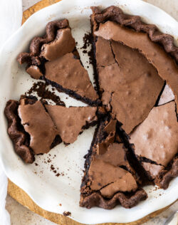 Top down view of brownie pie cut into slices with a crackly top.