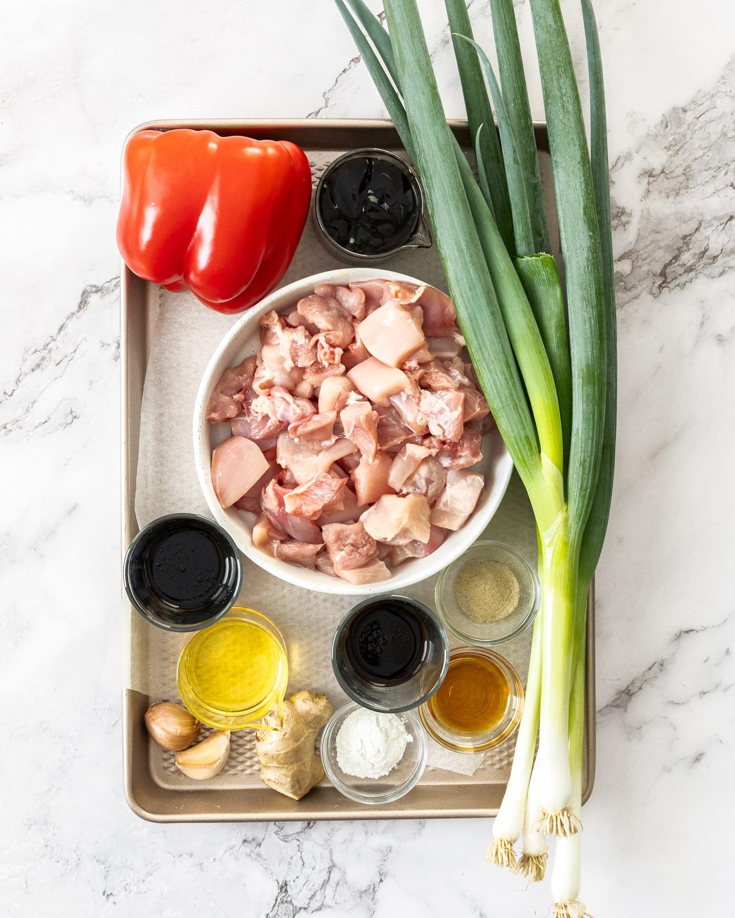 Ingredients for chicken in oyster sauce on a baking tray.