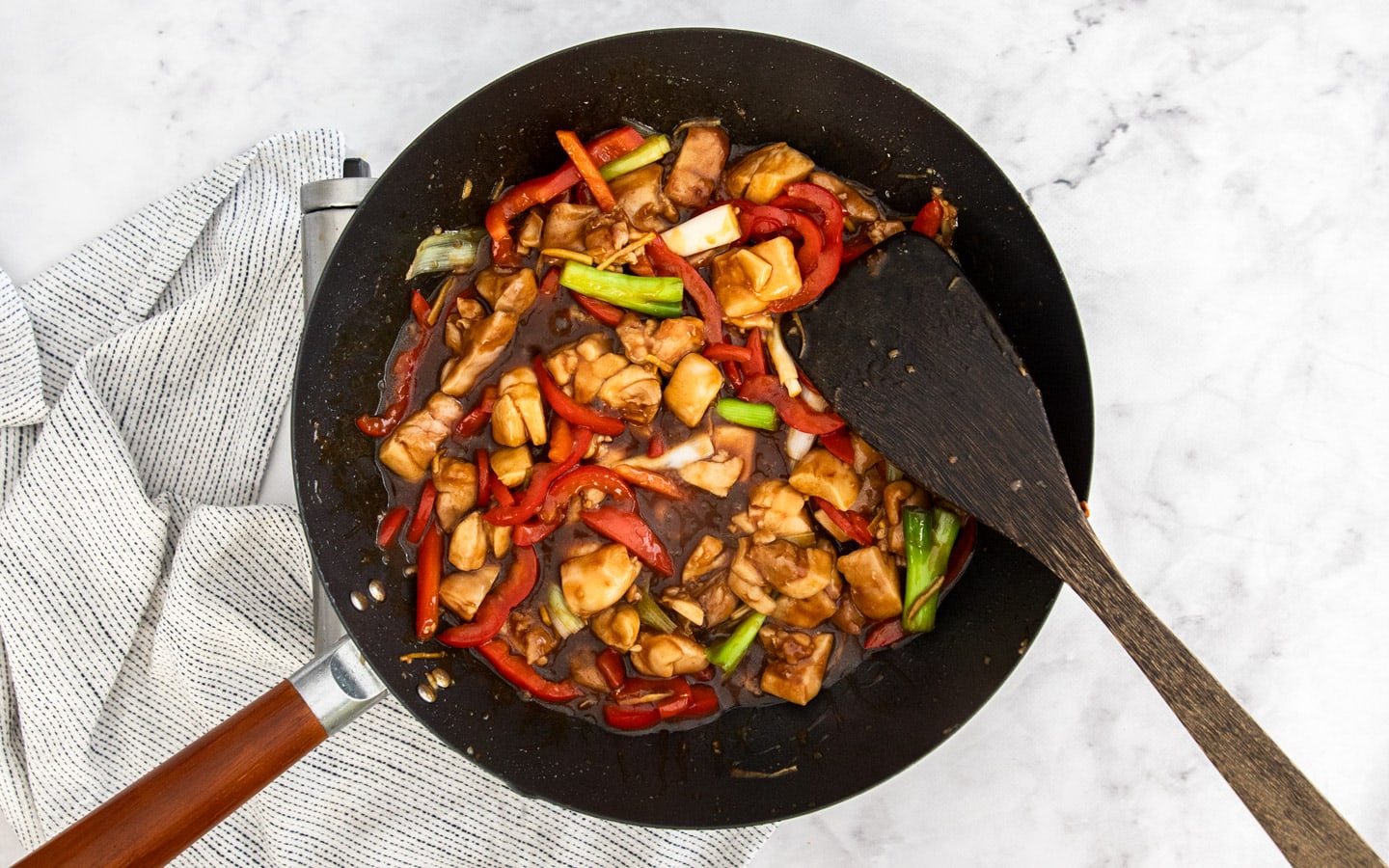 The chicken added back to the wok.