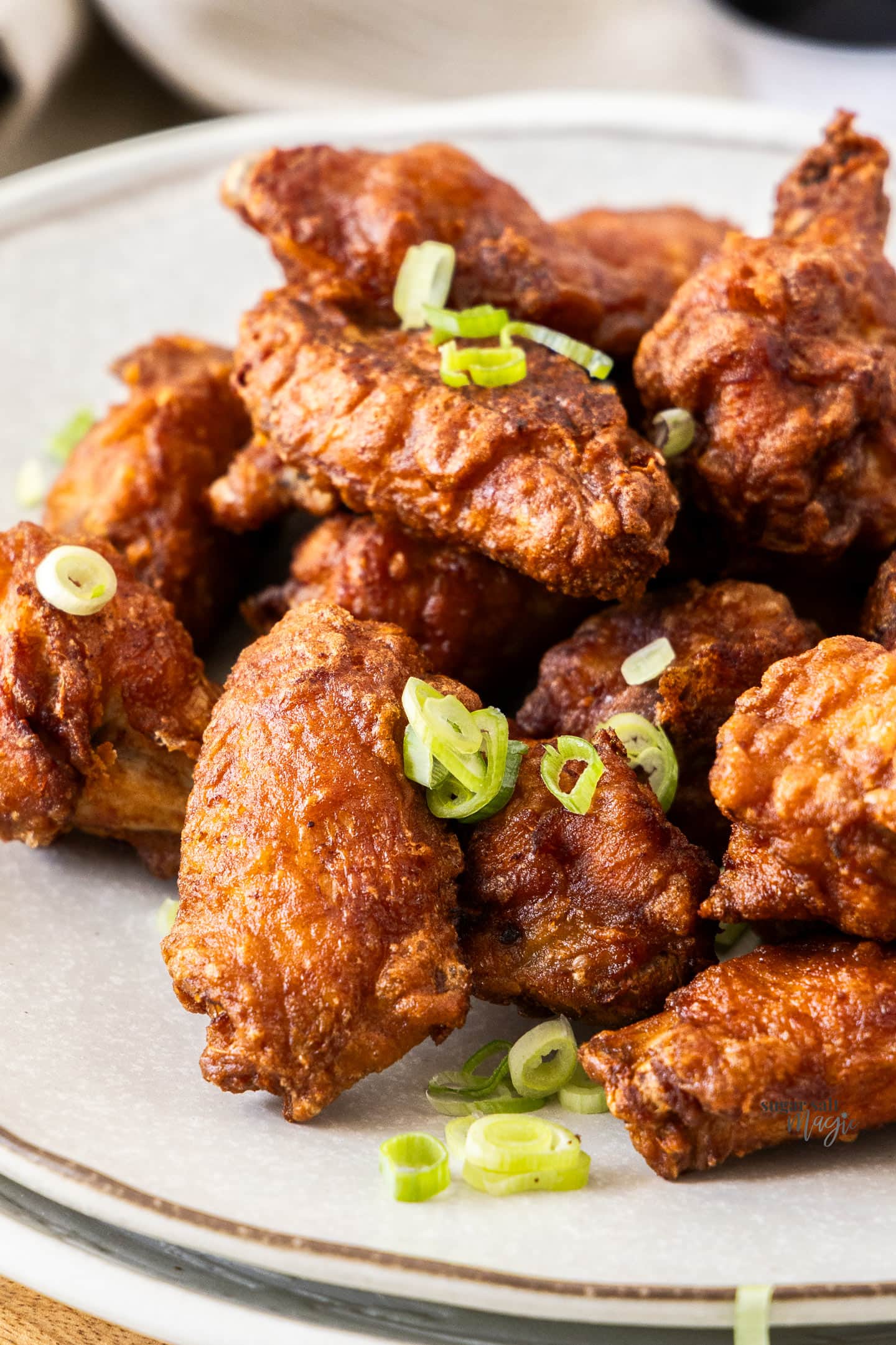 Closeup of a batch of fried chinese wings showing the crispy texture.