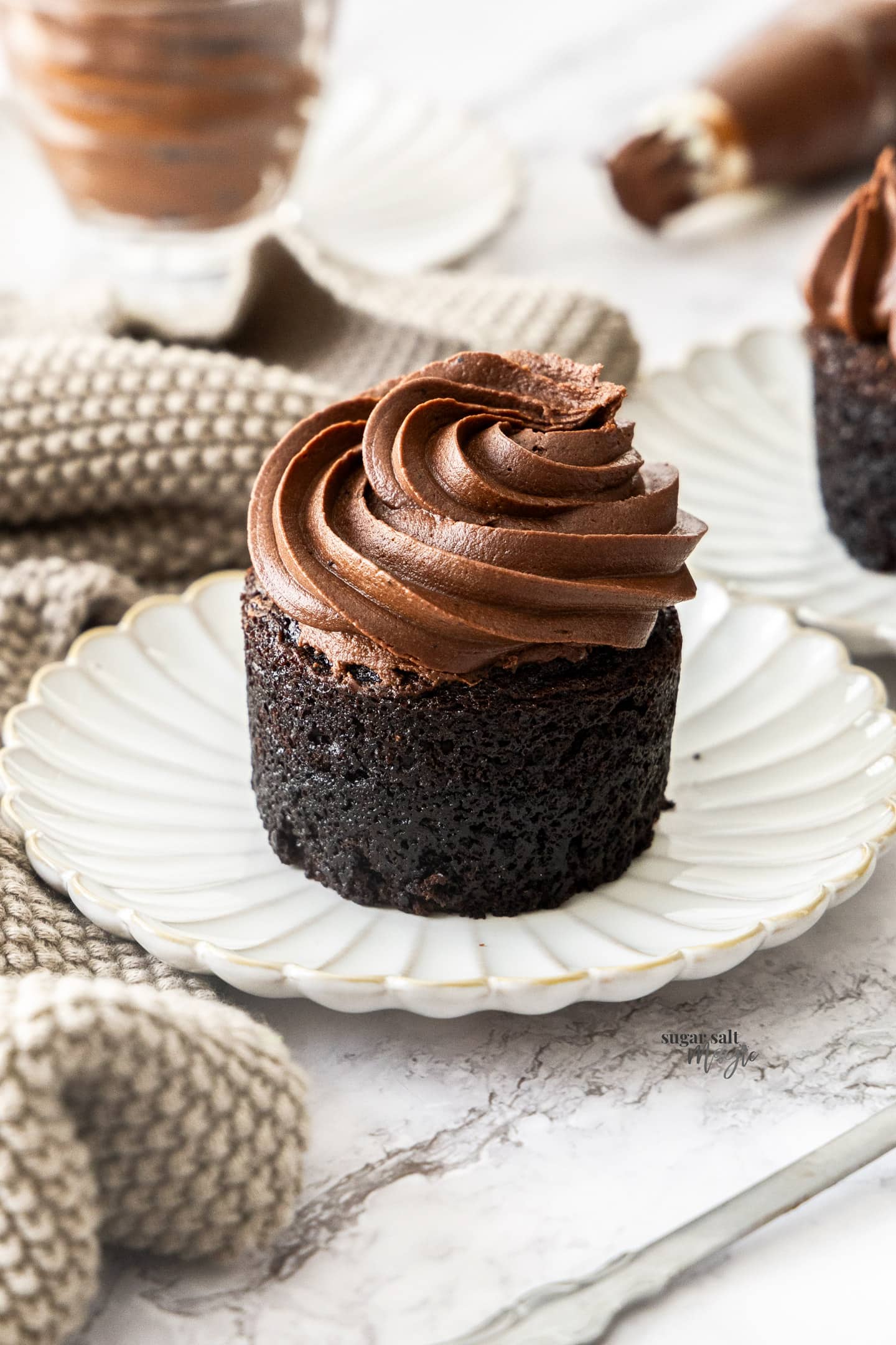 A cake topped with chocolate fudge frosting.
