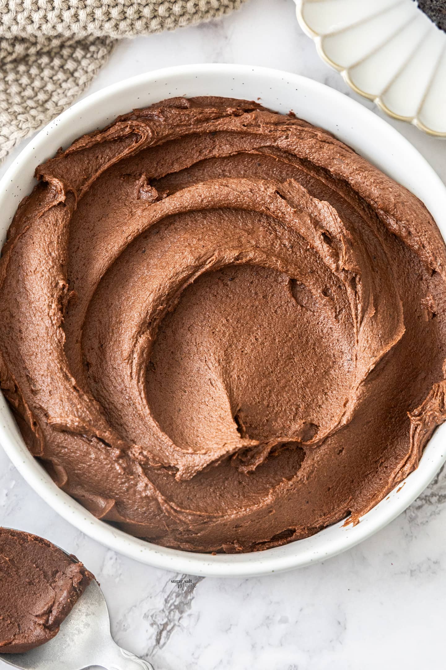 Swirls of fudge frosting in a bowl.