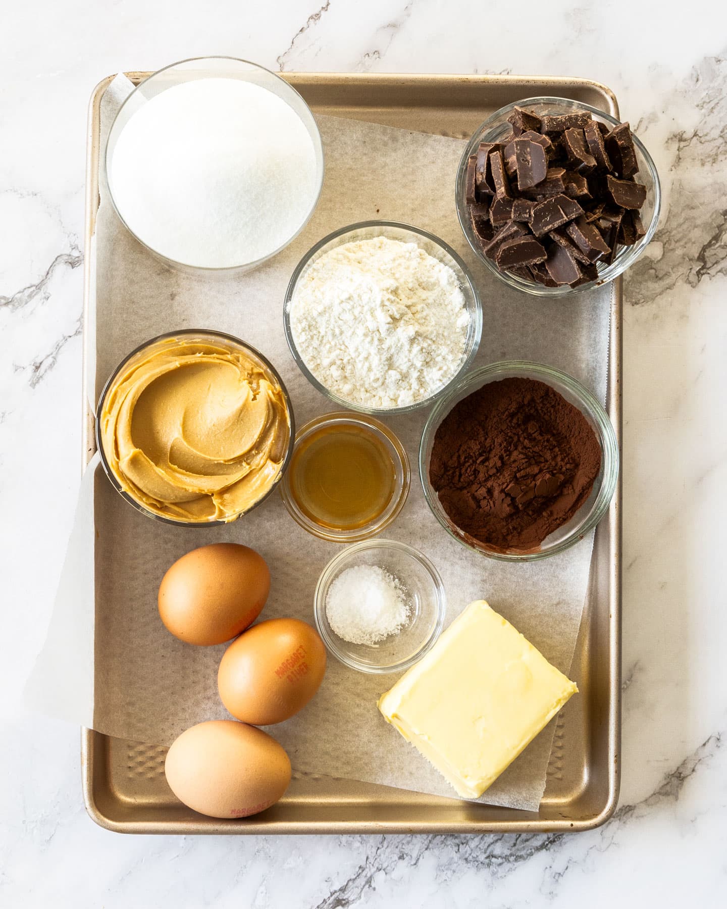 Ingredients for peanut butter brownies on a baking tray.