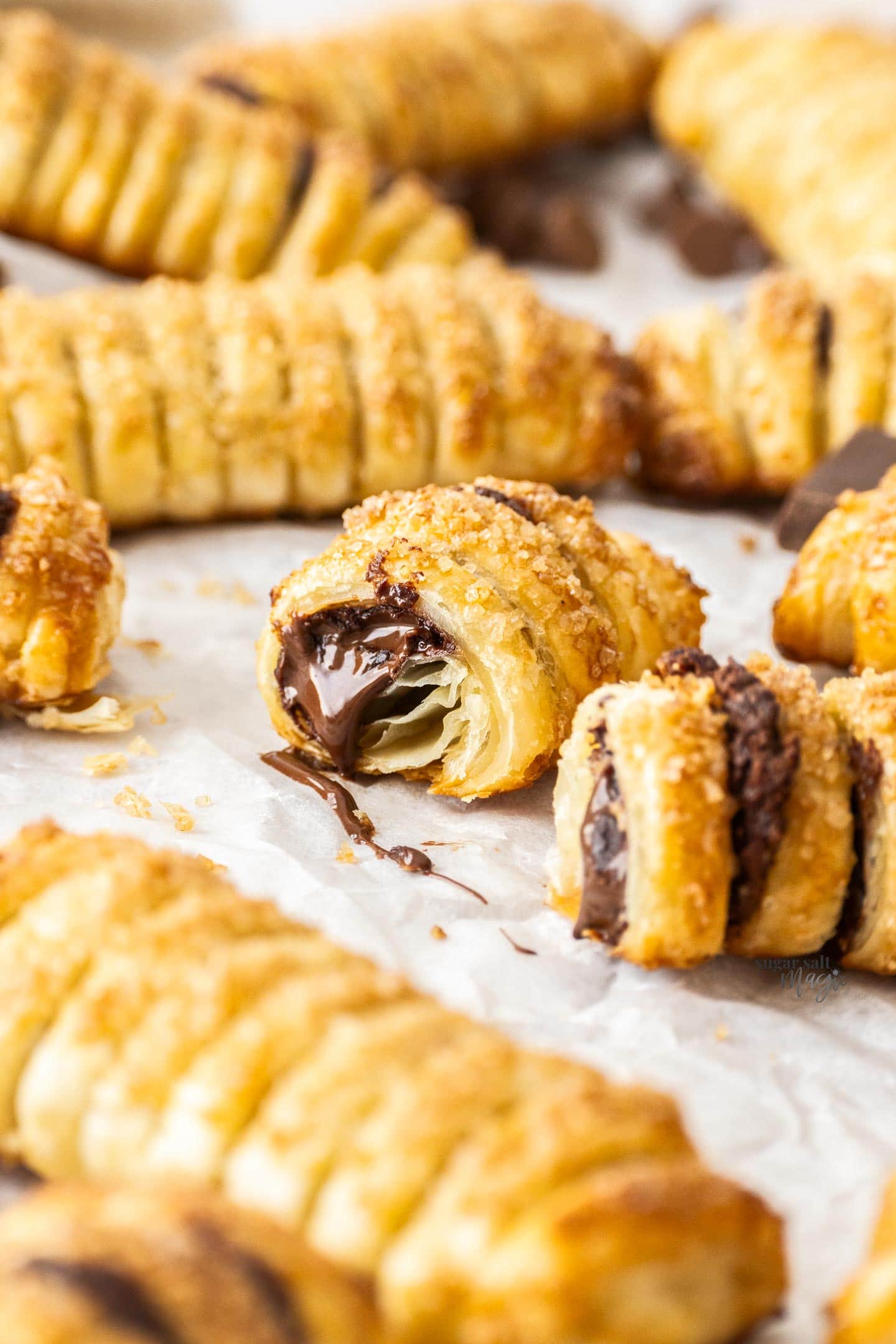 A chocolate puff pastry broken open to show the gooey chocolate inside.