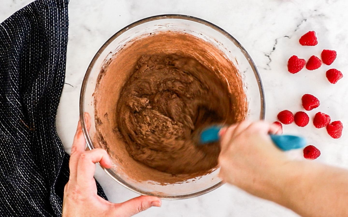 Mixing cocoa into the brownie batter.