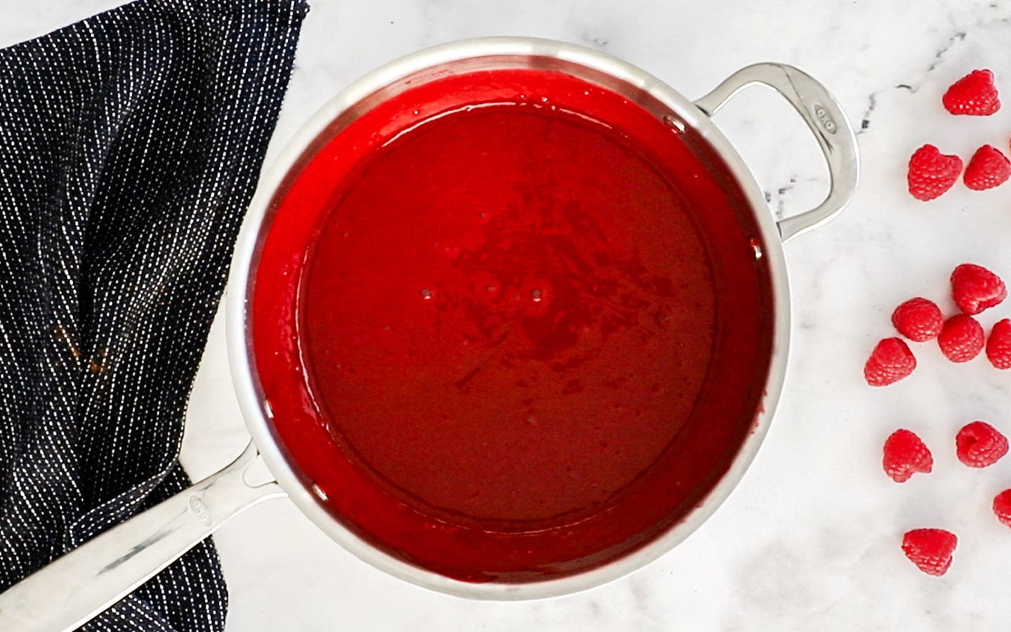 Raspberry sauce in a saucepan.