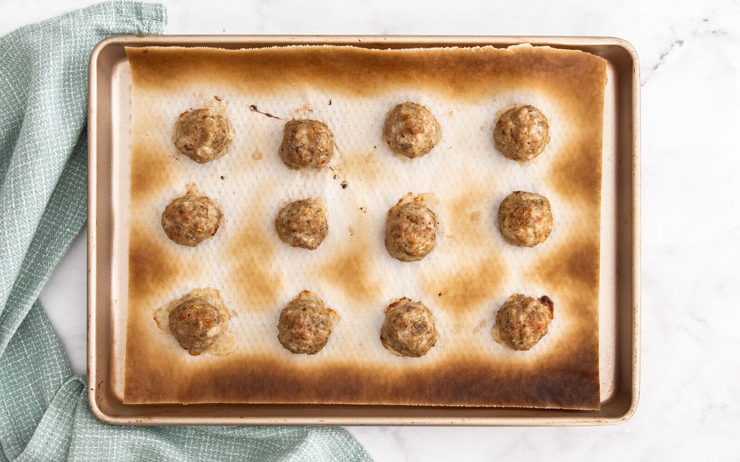 The cooked meatballs on a baking tray.