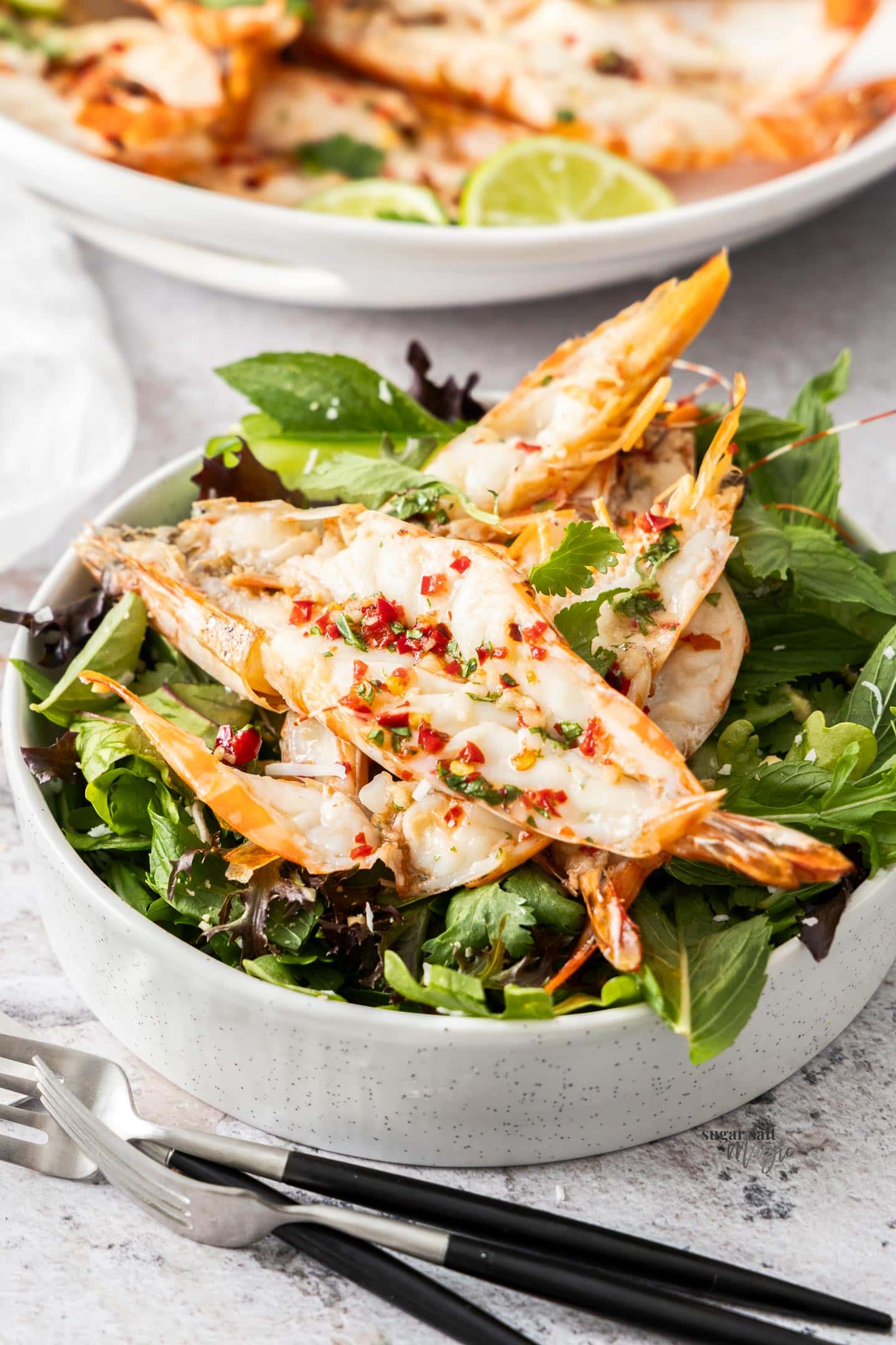 butterflied prawns on top of a salad.