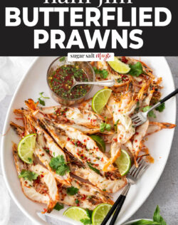 A platter loaded with butterflied prawns.