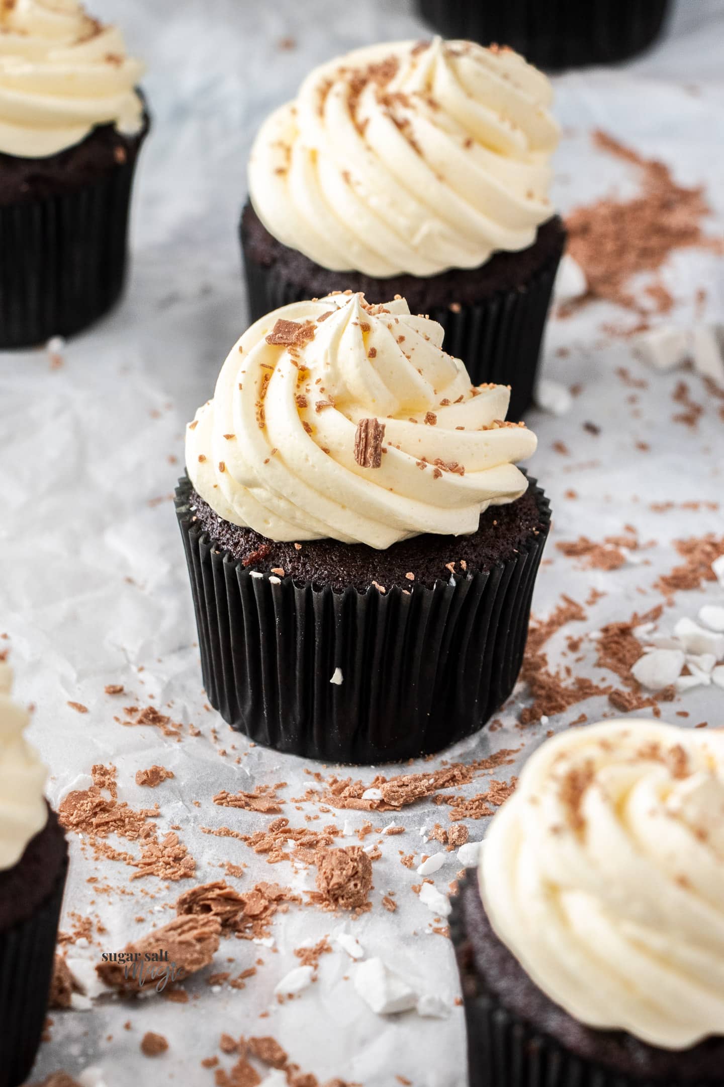 A chocolate cupcake topped with a swirl of buttercream.