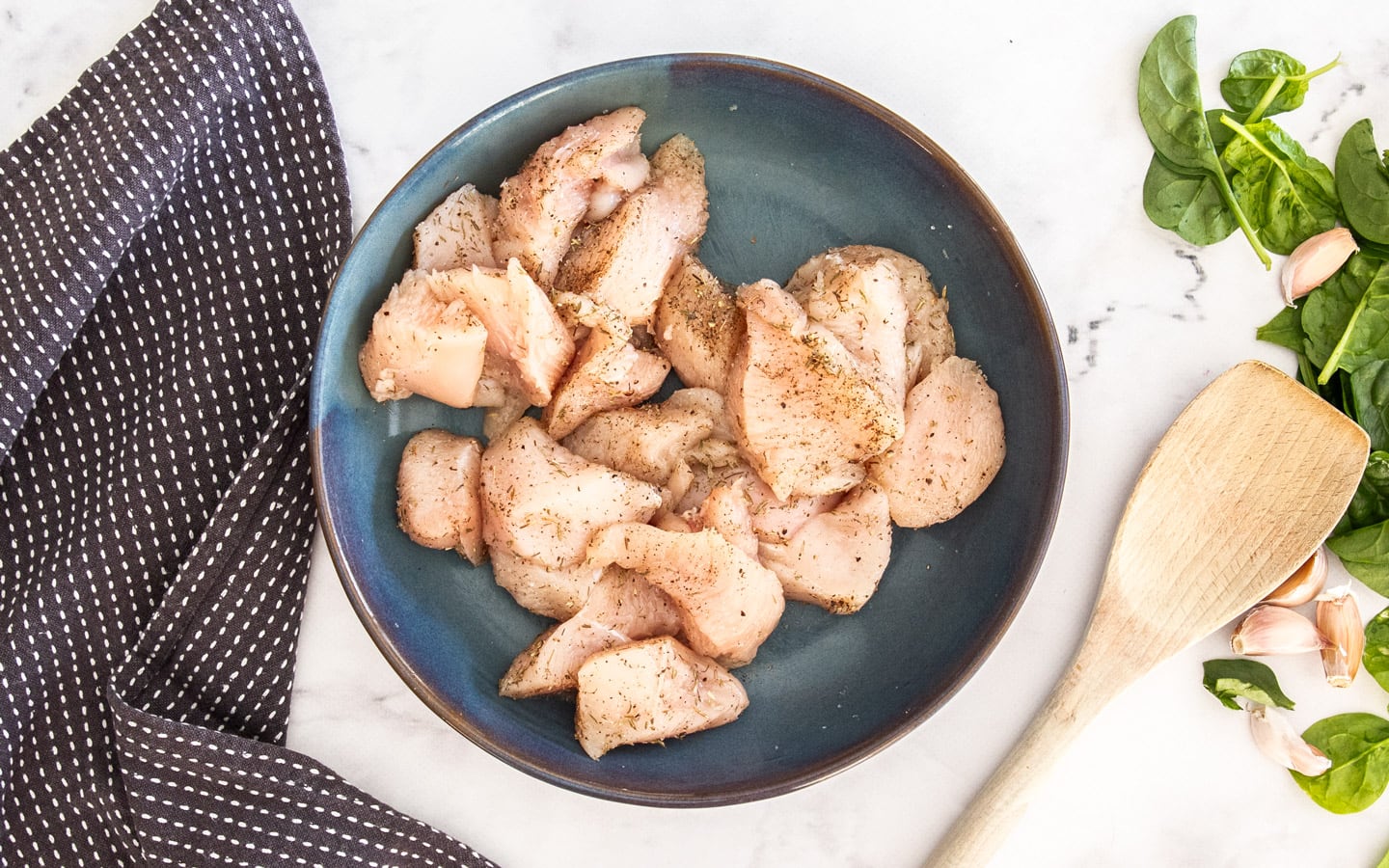 The seasoned chicken pieces in a bowl.