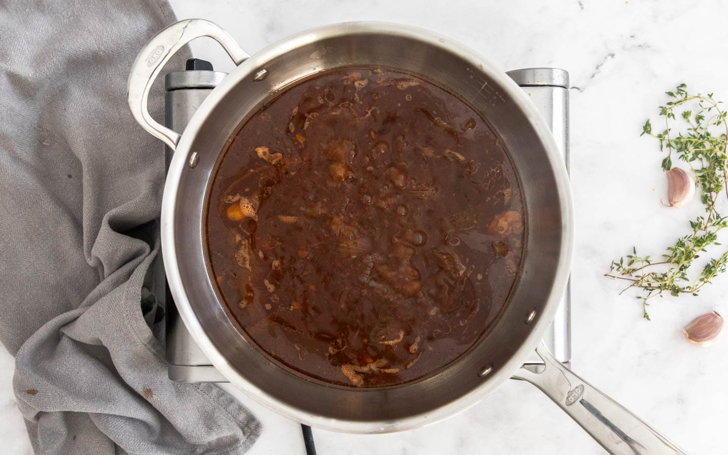 The gravy bubbling in a saucepan.