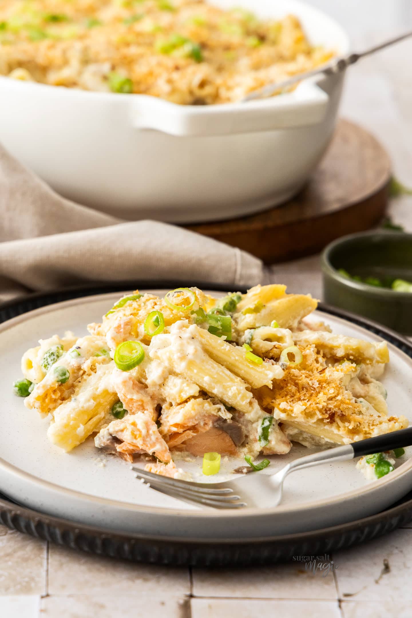 A serve of baked salmon pasta on a dinner plate.