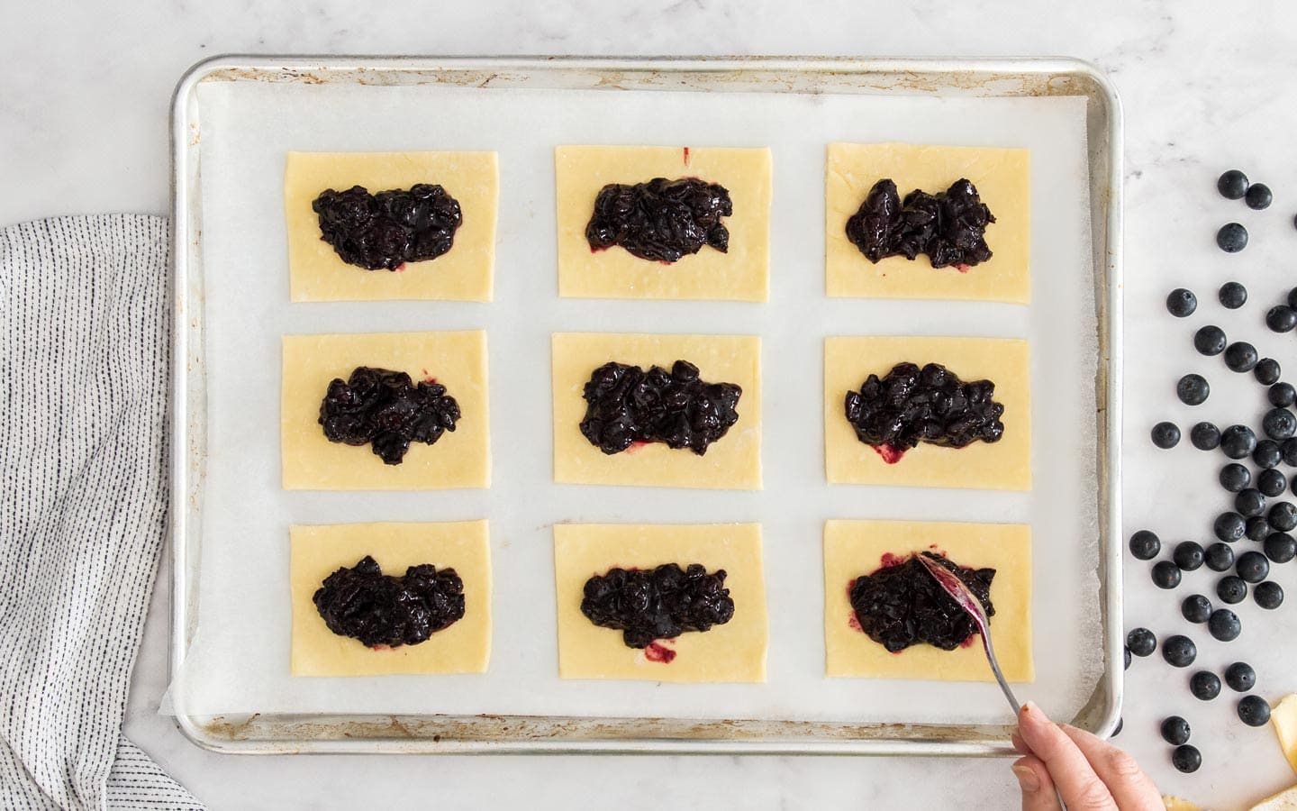 The rectangles of dough topped with blueberry jam.