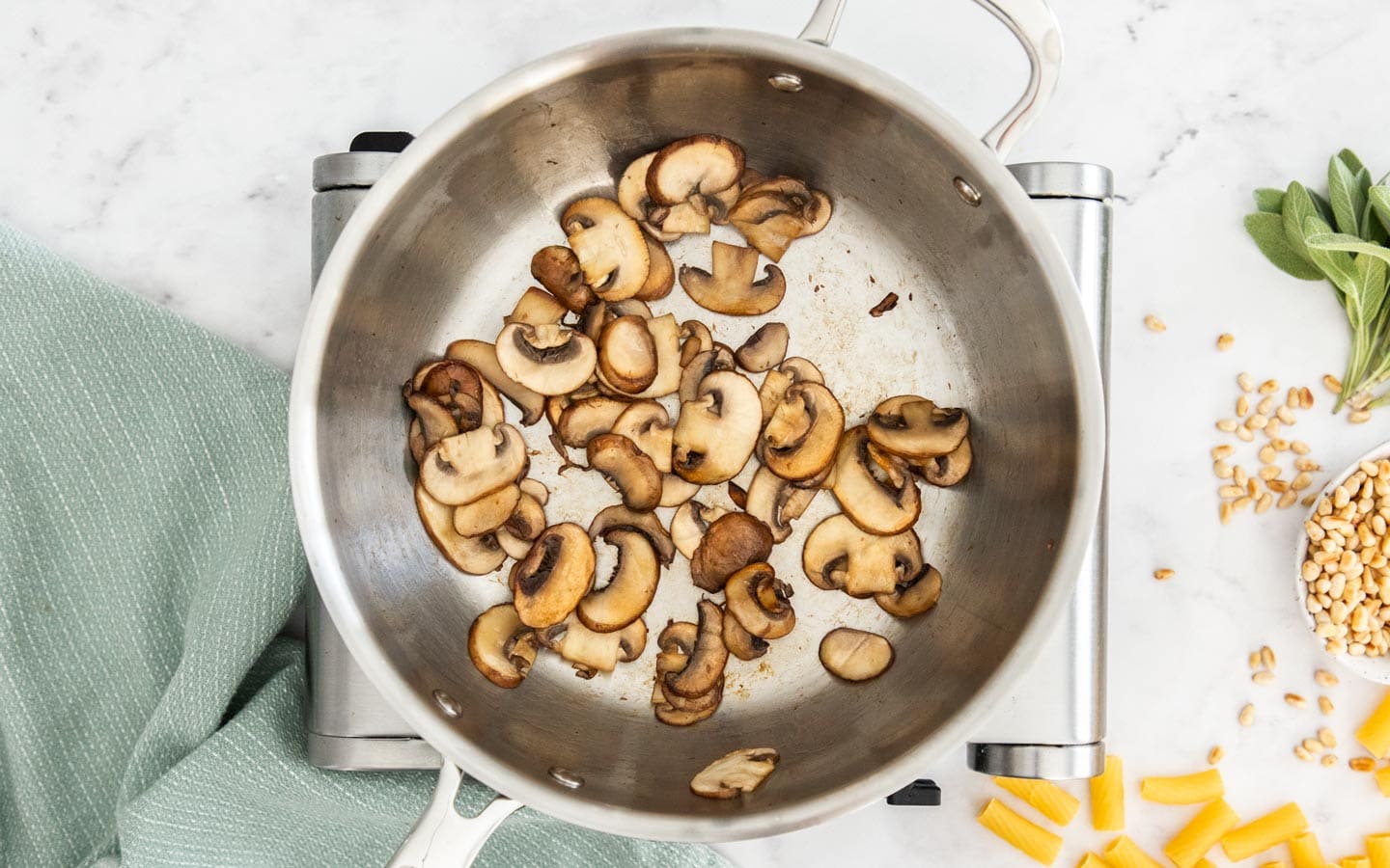 Mushroom being sauteed in a pan.