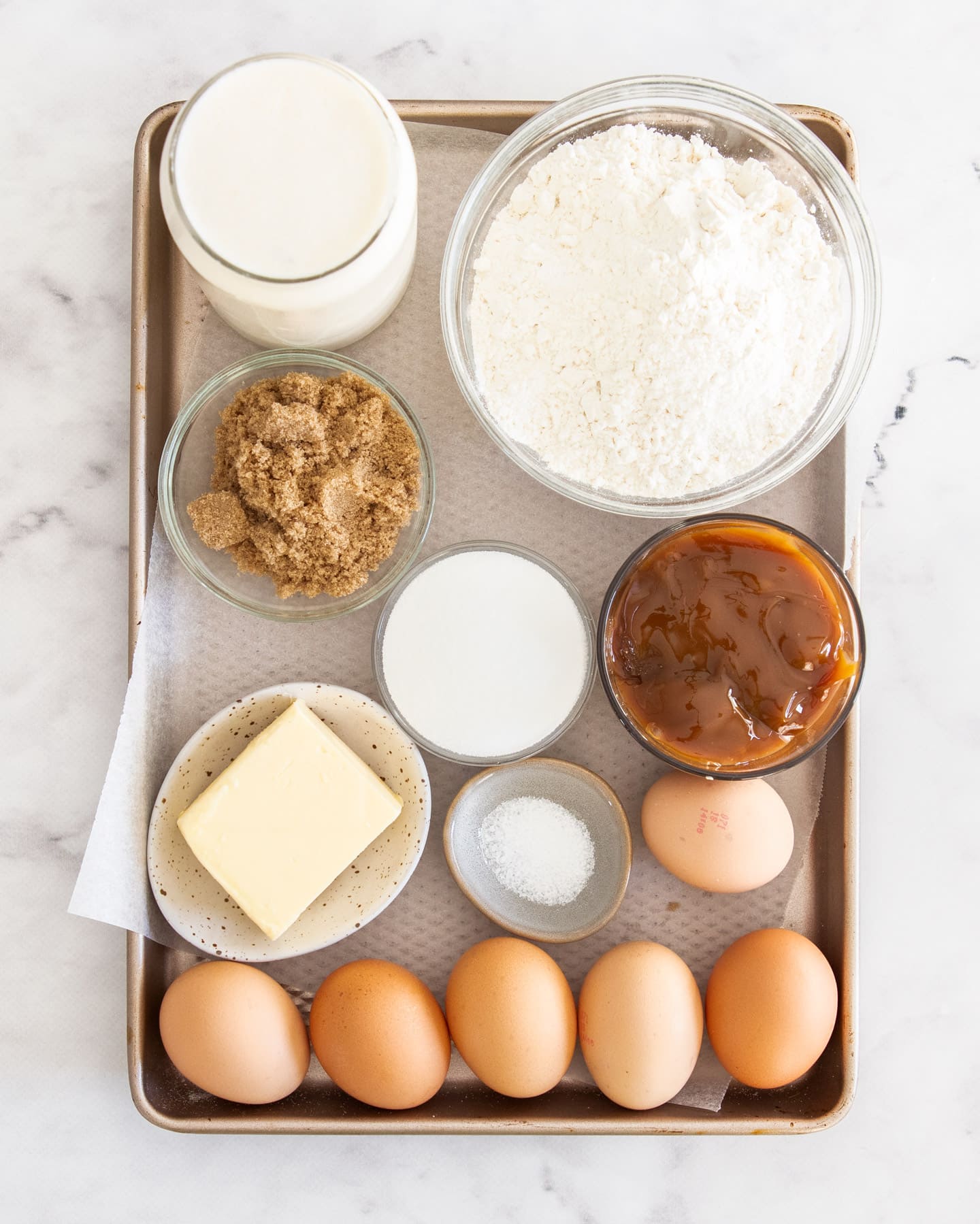 Ingredients for caramel creme brulee tart on a baking tray.