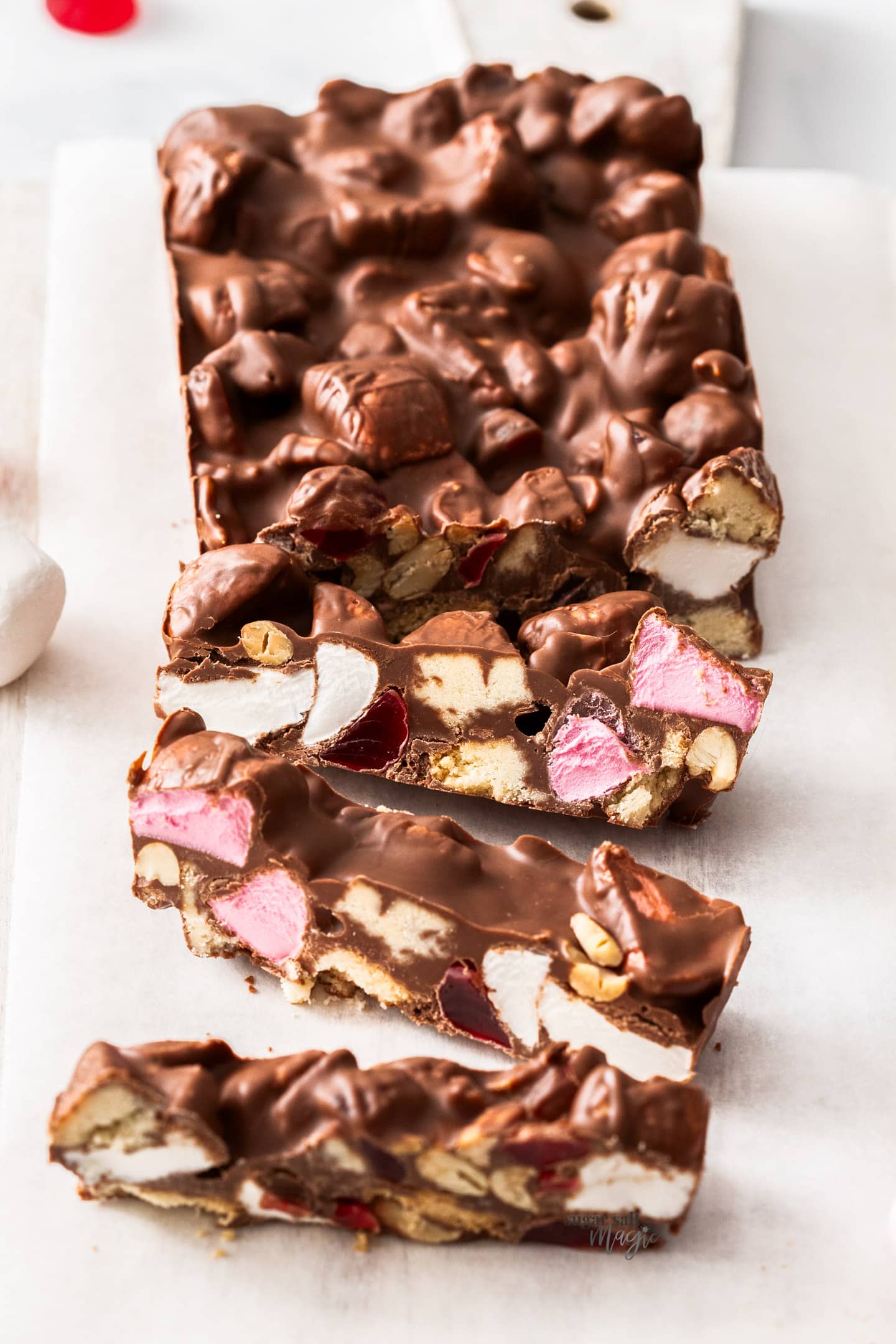 A batch of rocky road with 3 slices cut.