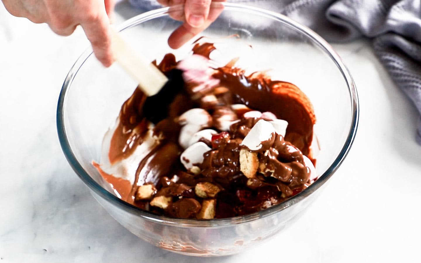 Rocky road ingredients being mixed in a bowl.