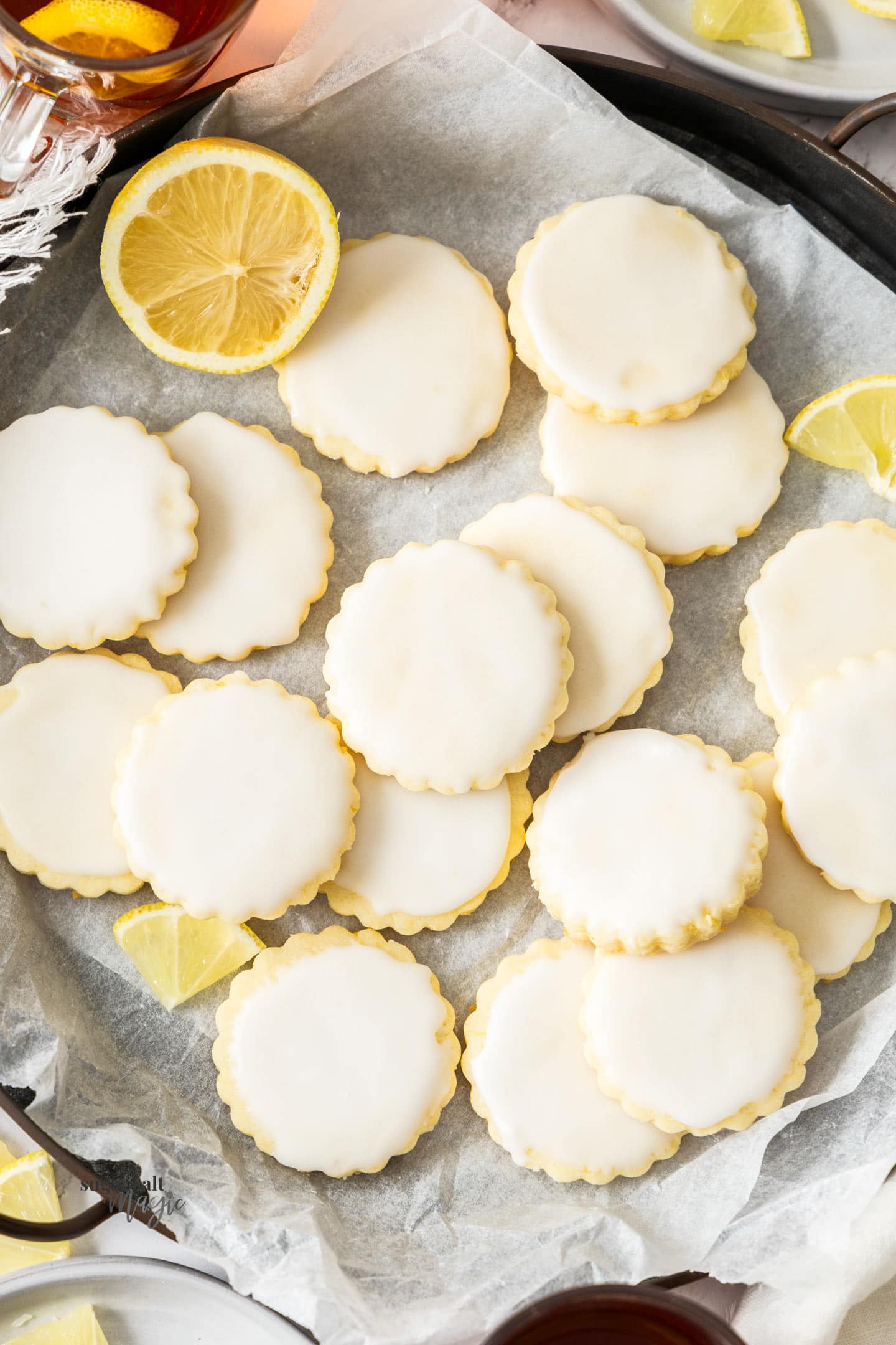 Top down view of a batch of iced lemon cookies.