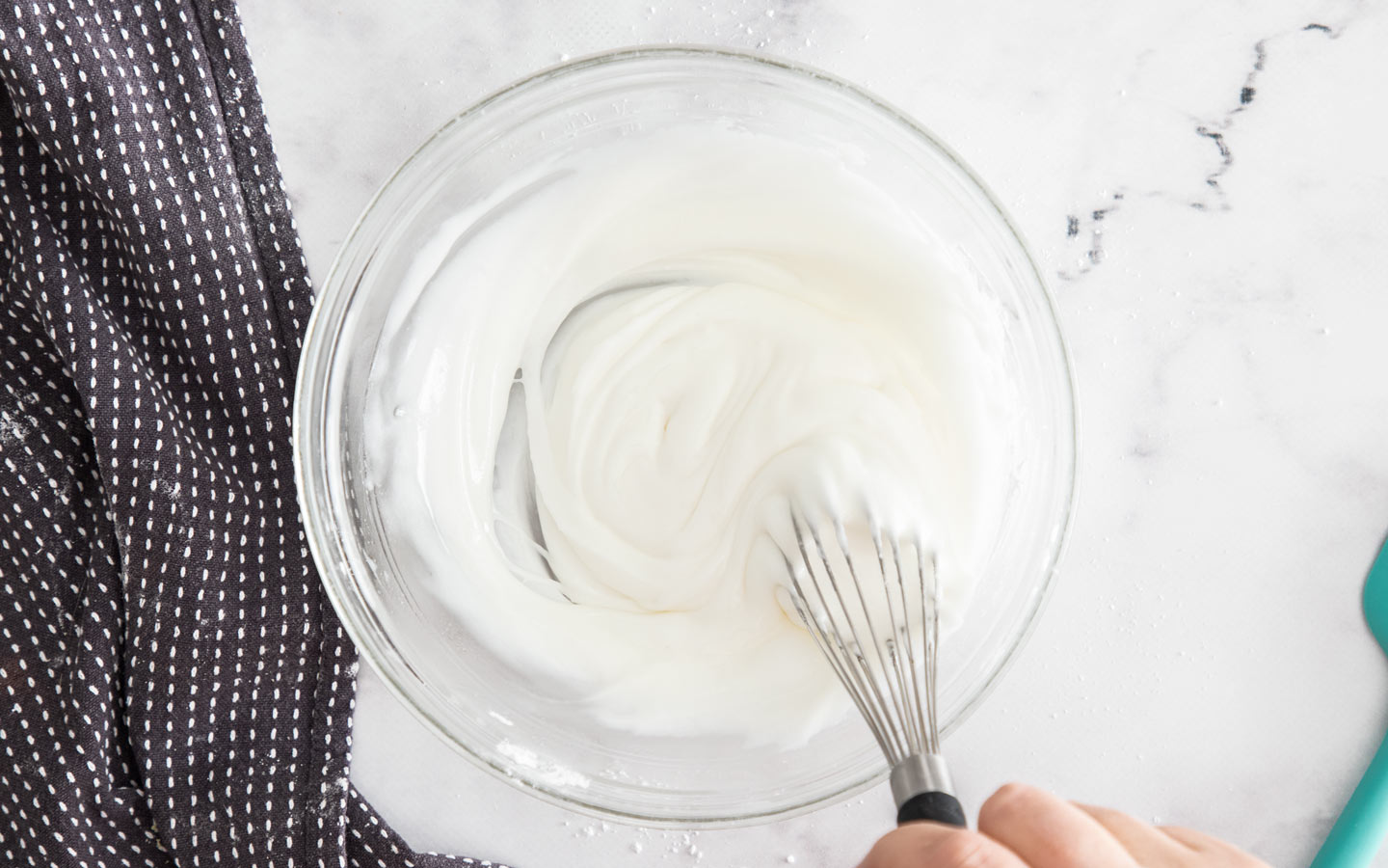 Whisking the icing in a bowl.