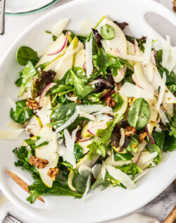 Walnut & pear salad in a white serving platter.