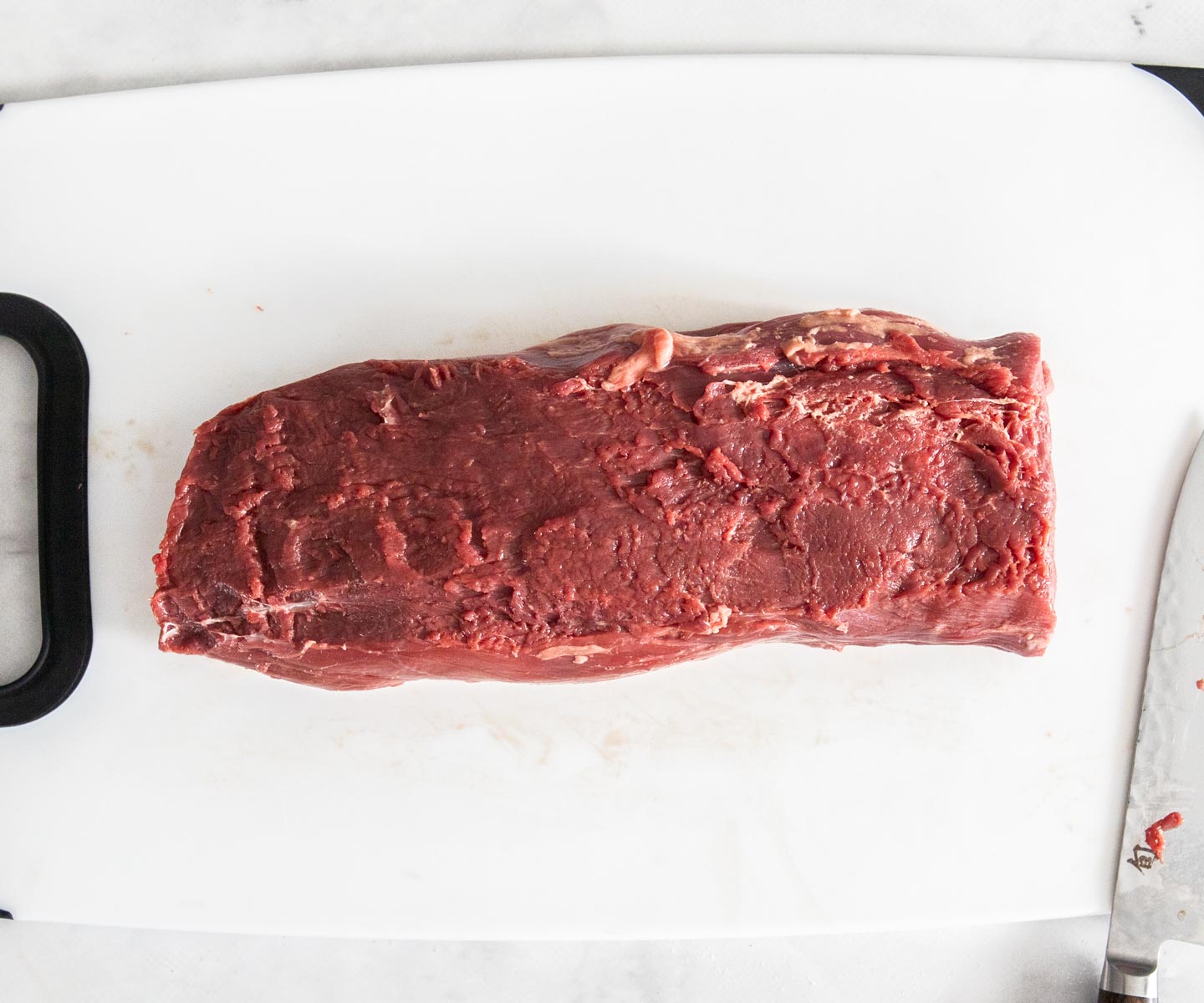 Bacon-wrapped Beef Tenderloin A raw beef tenderloin ready to season and roast.