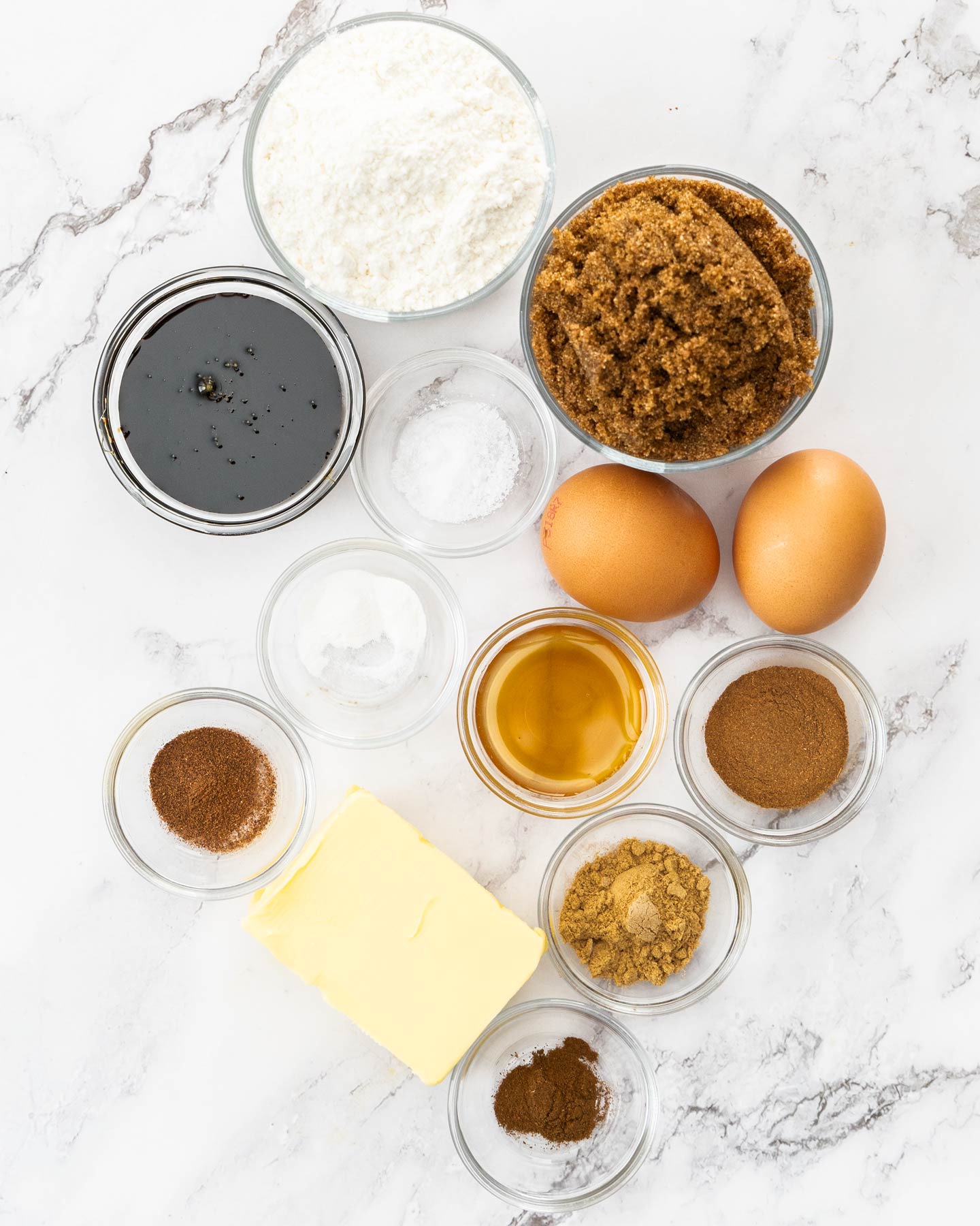 Ingredients for gingerbread blondies on a marble surface.