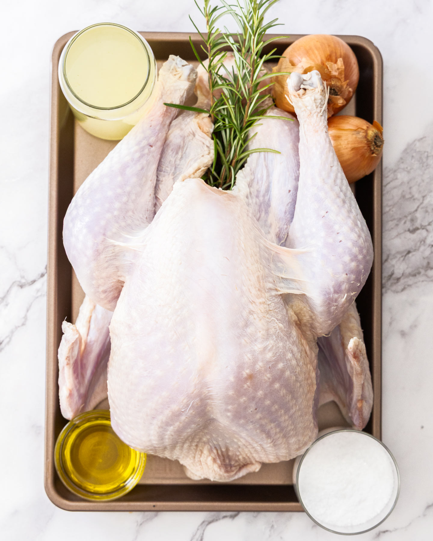 Ingredients for whole roast turkey on a metal tray.