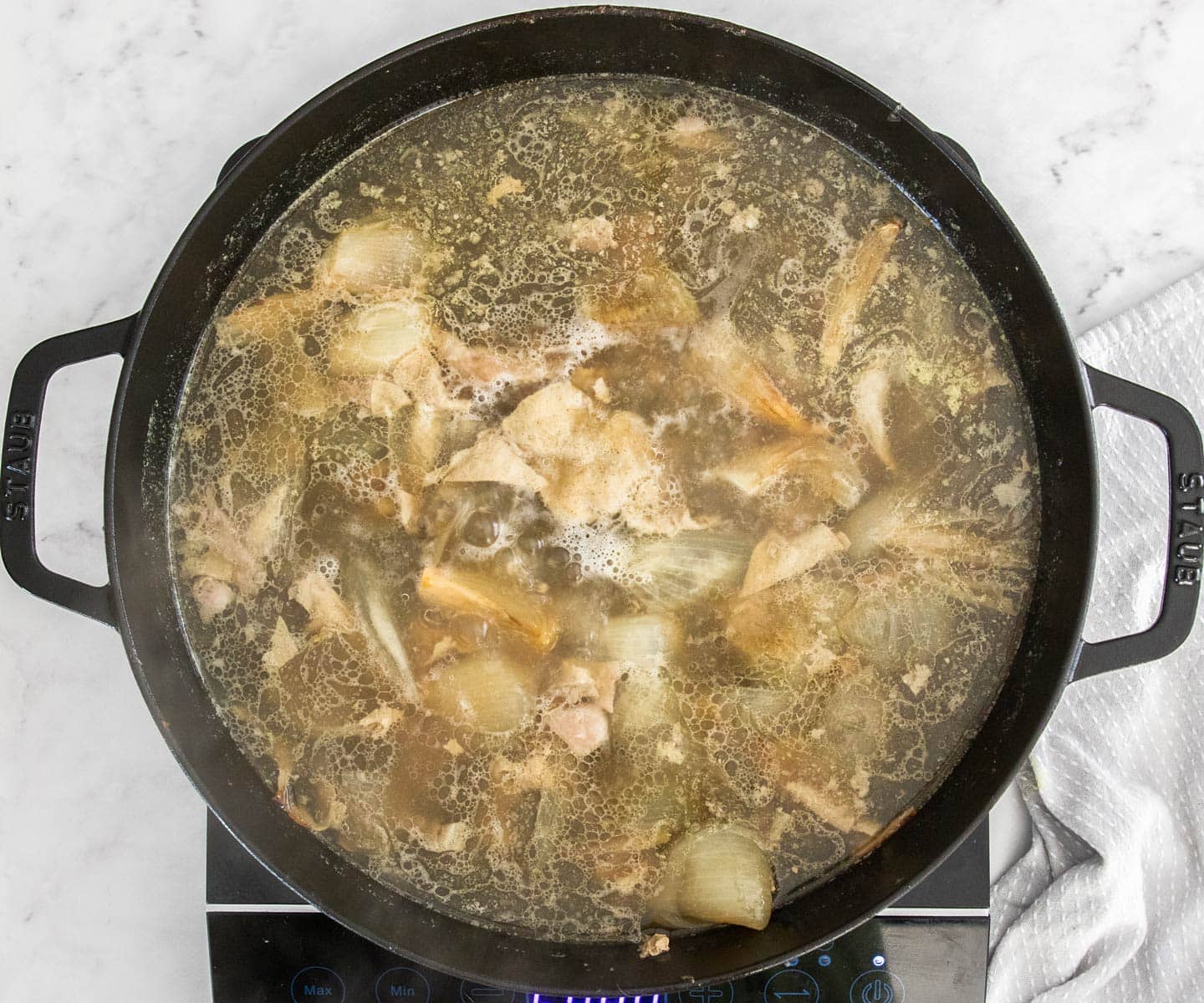 The turkey pan juices in a skillet starting to boil
