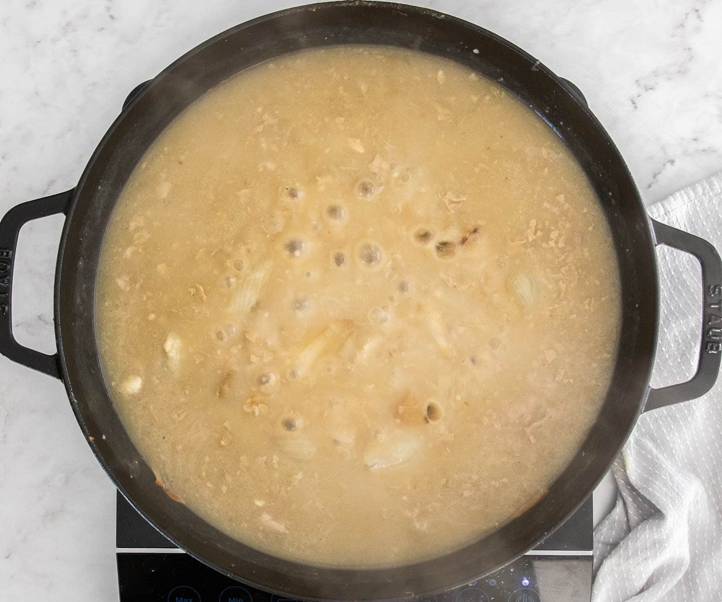 The turkey pan juices bubbling in a pan with flour whisked in.