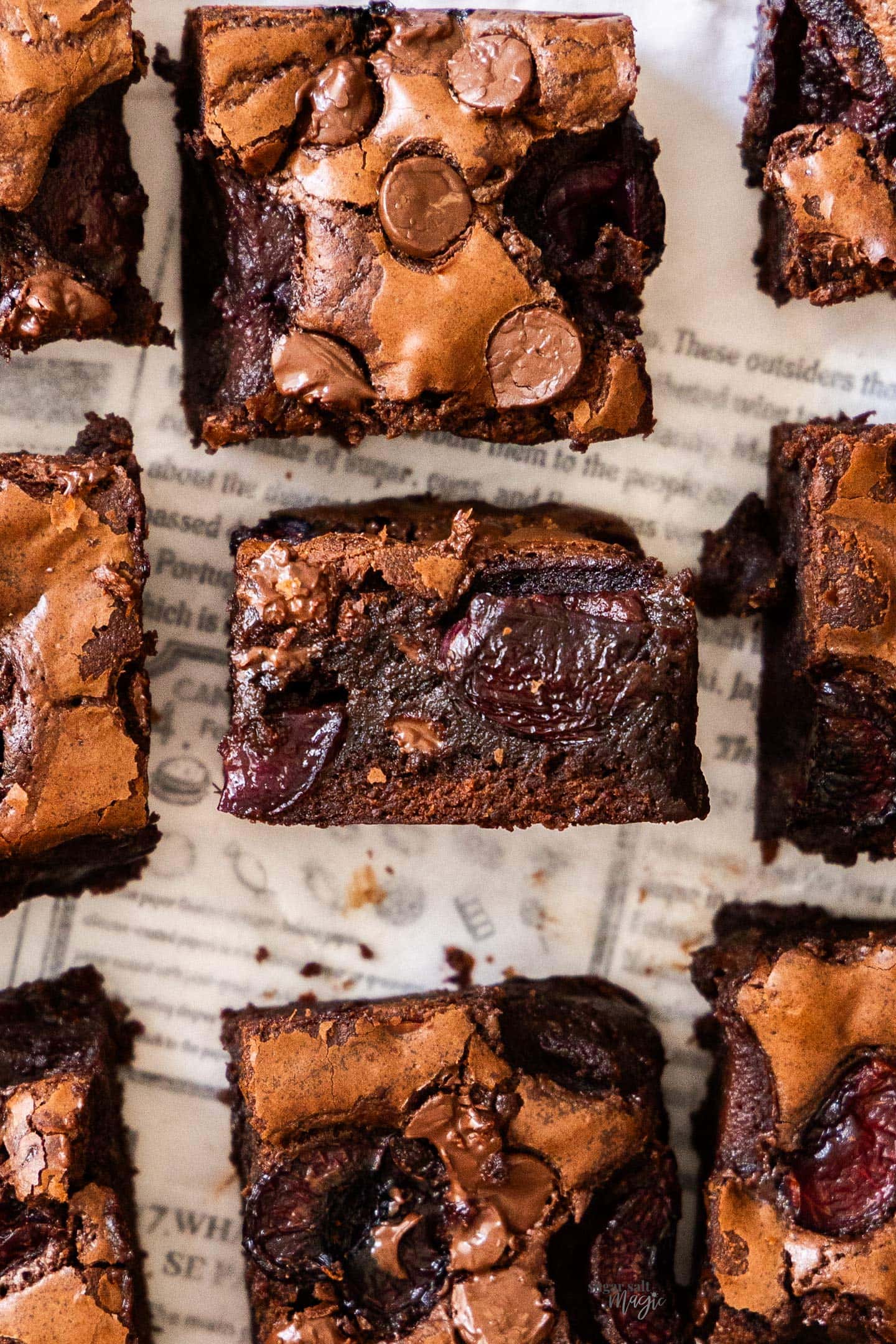 Top down view of 9 brownies with the middle standing up to show the inside texture.