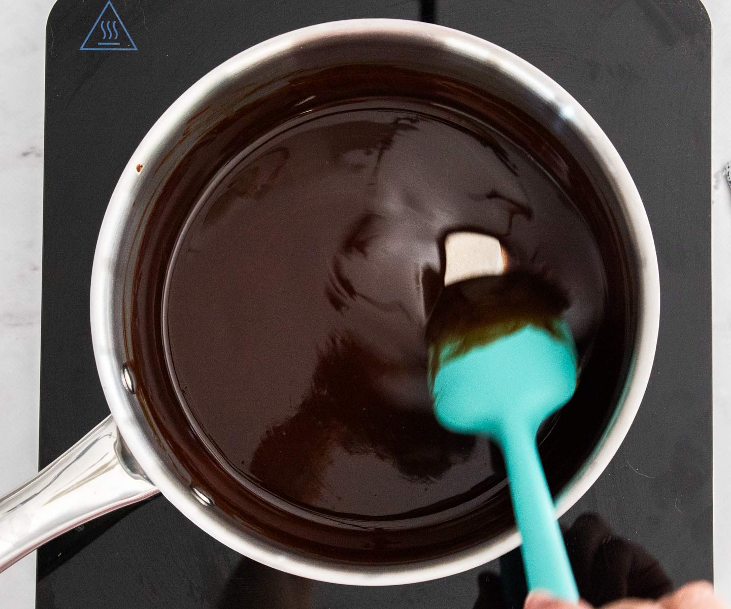 Cherry Crumble Stirring melted butter and chocolate in a saucepan.