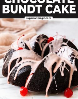 Front on view of cherry chocolate bundt cake on a marble platter.